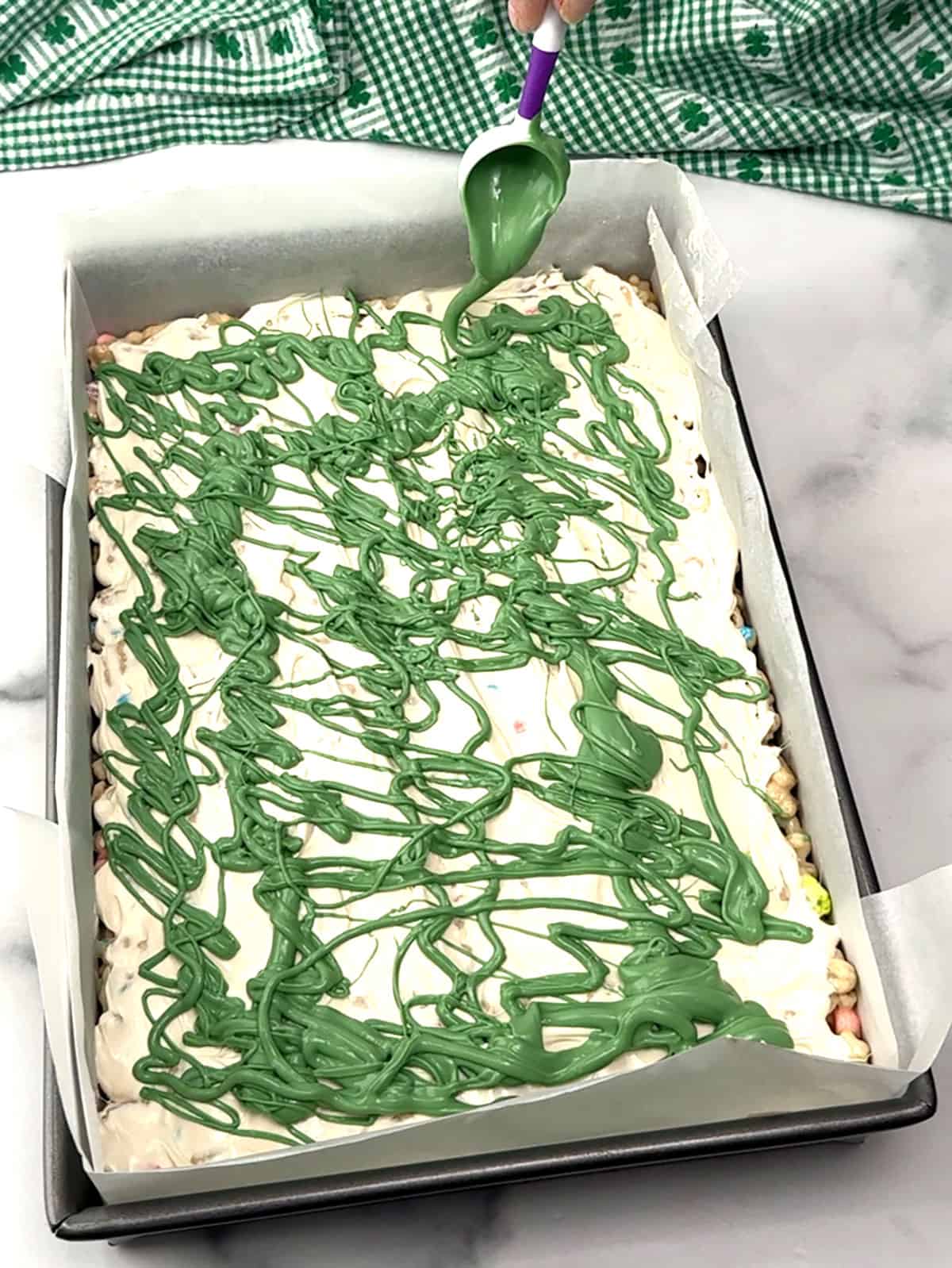 drizzling green candy melts over white
