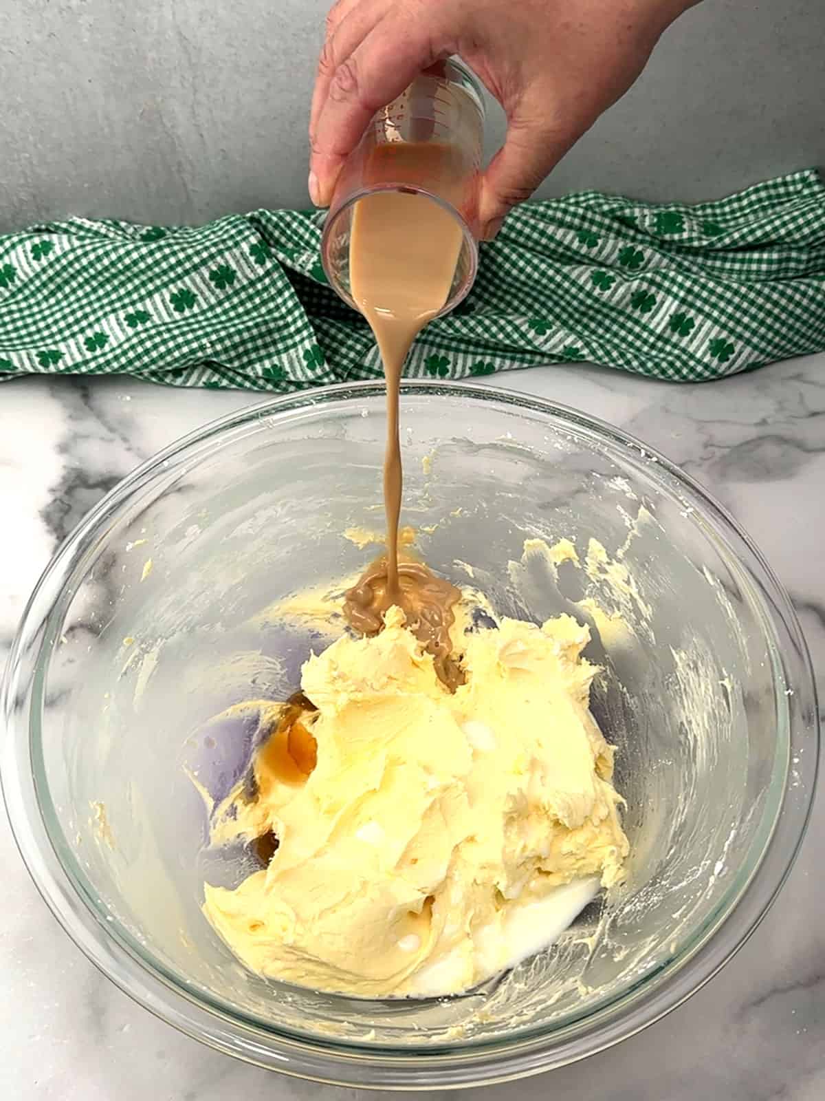 adding liquid ingredients to frosting