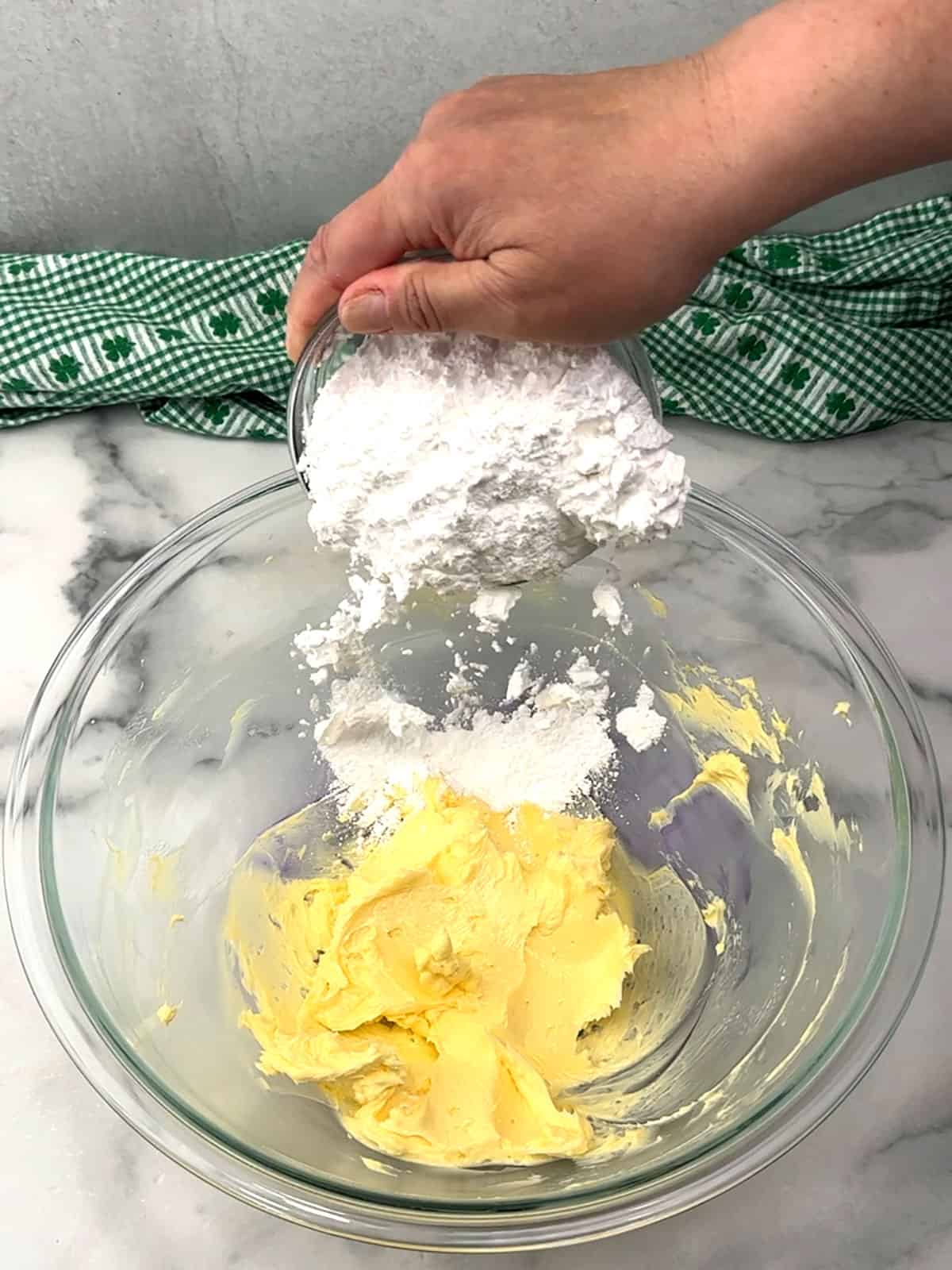 adding powders sugar to butter for frosting