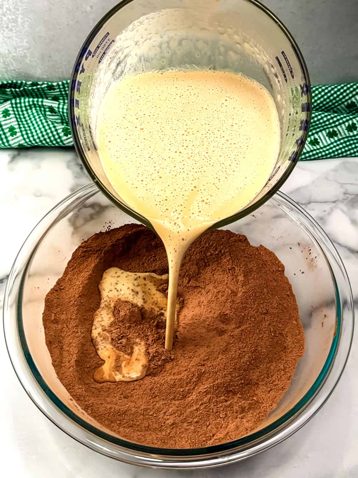 adding liquid ingredients to dry for cake