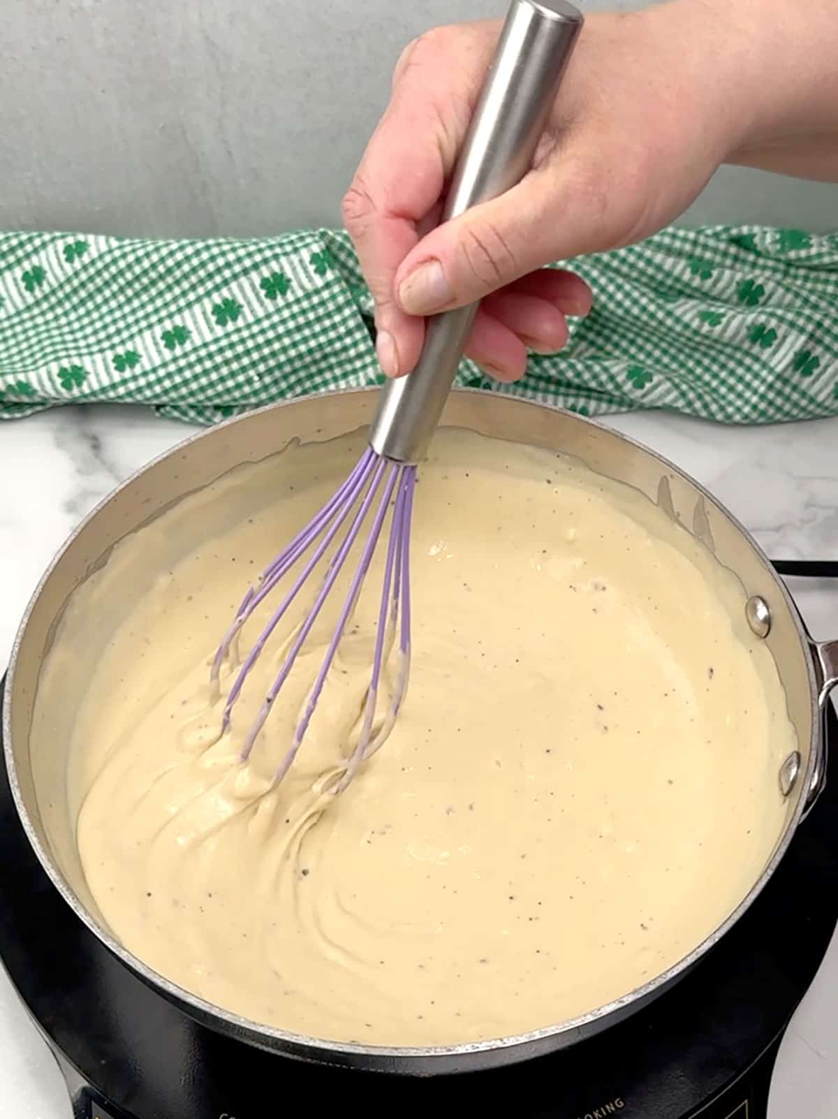 whisking cheese sauce
