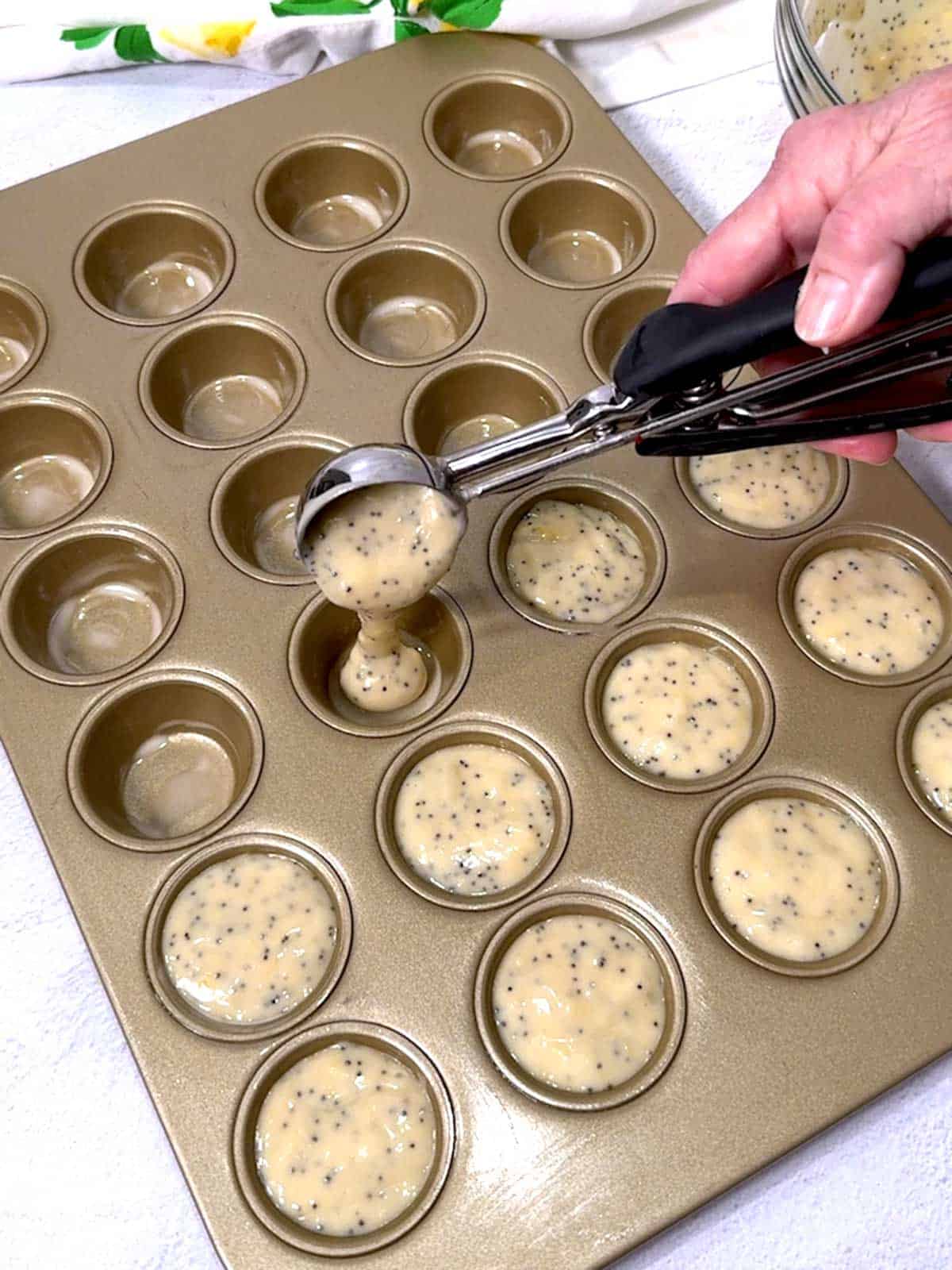 Adding batter to mini-muffin pan.