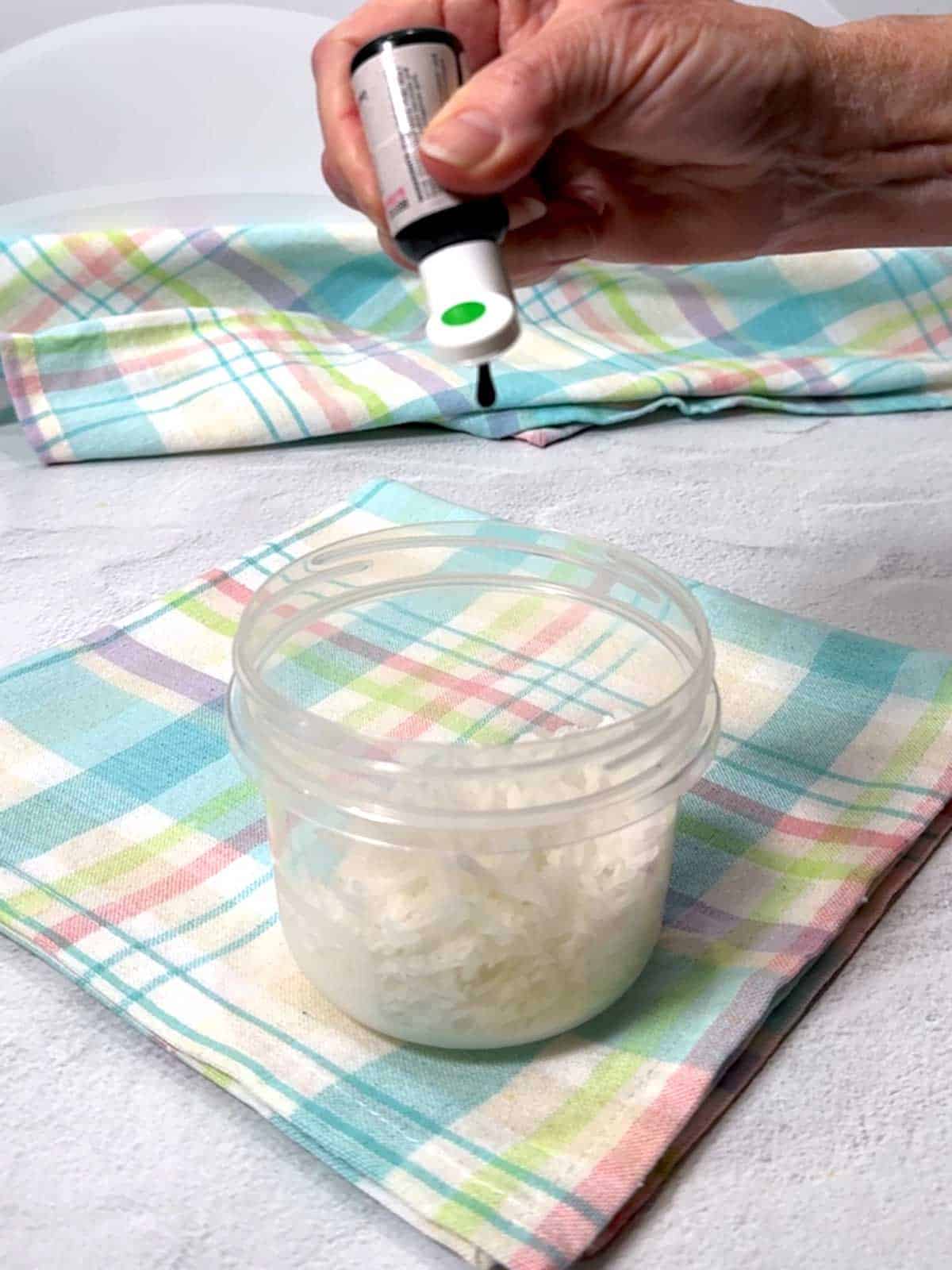 Adding green food color to the coconut.