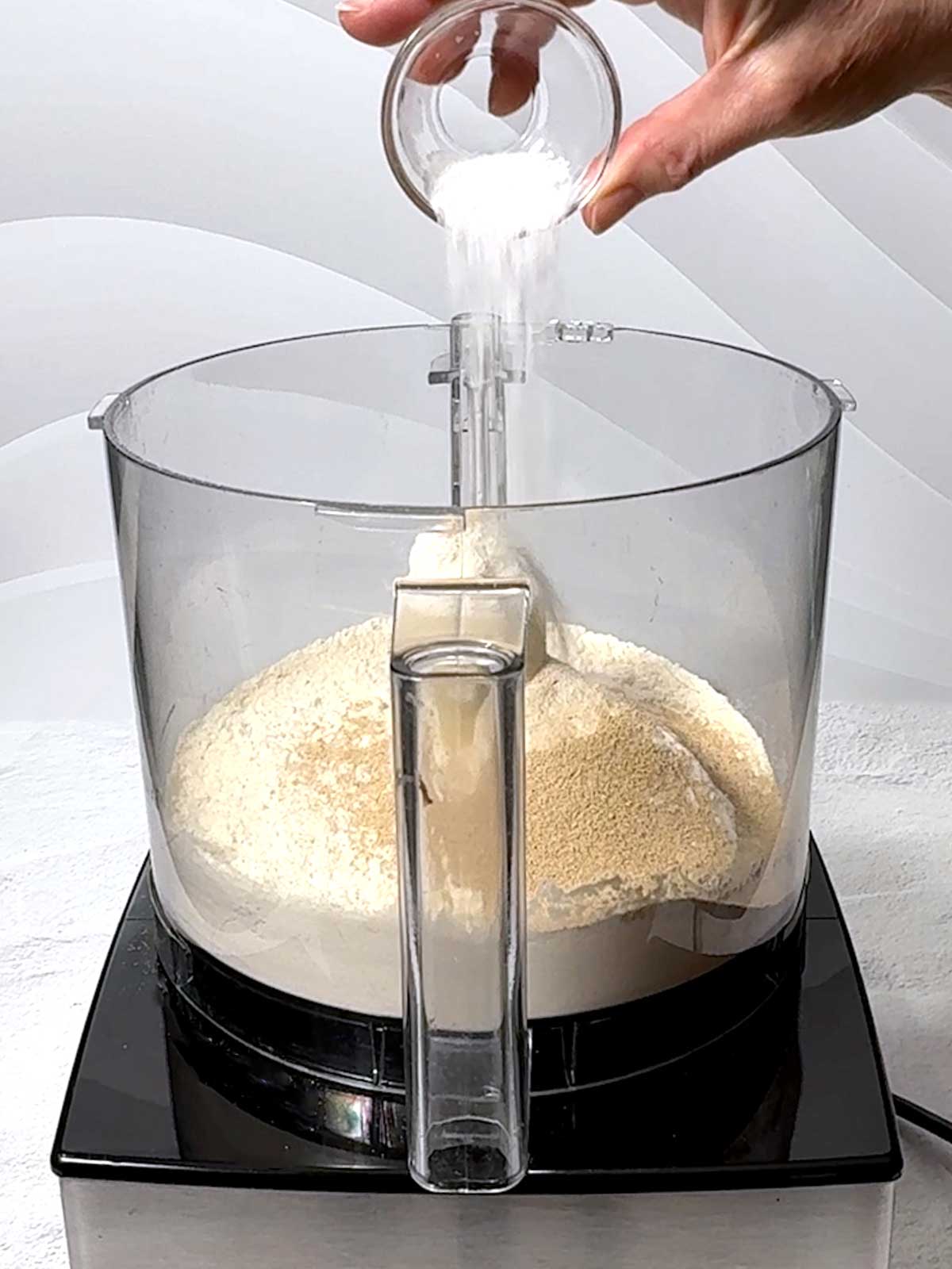 Adding salt to the food processor.