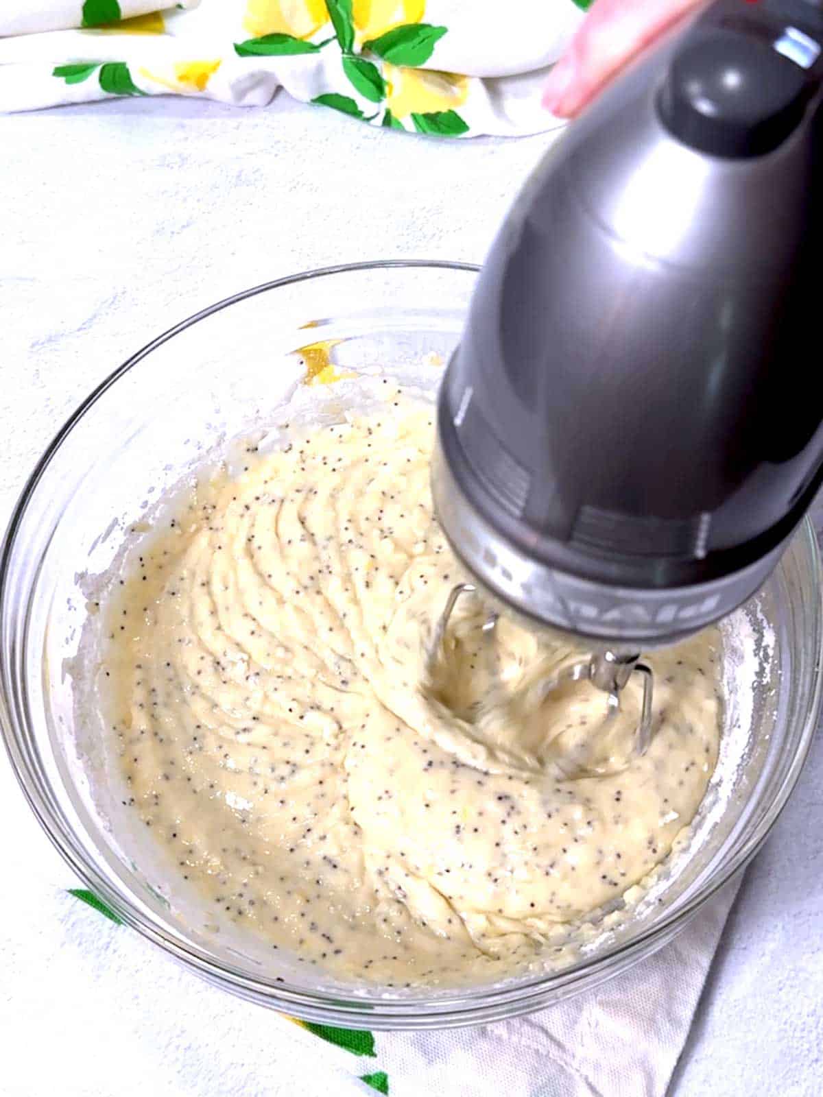 Beating flour into the wet ingredients.