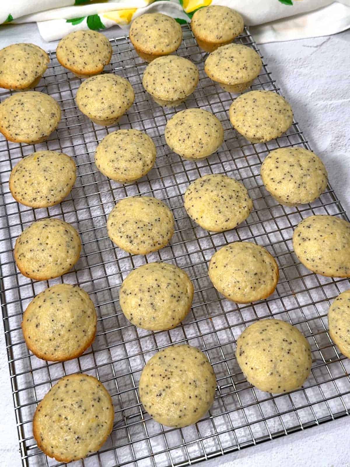 Lemon mini-muffins cooling on wire rack.