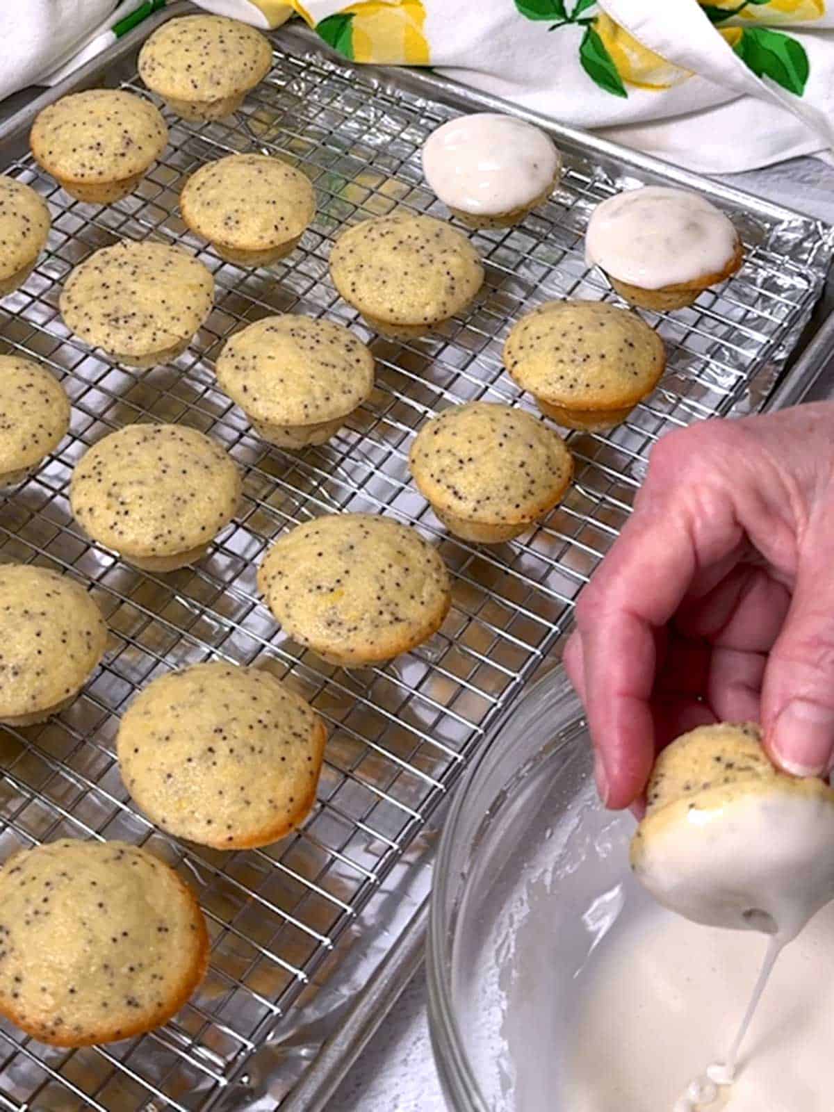 Dipping mini-muffin in the glaze.