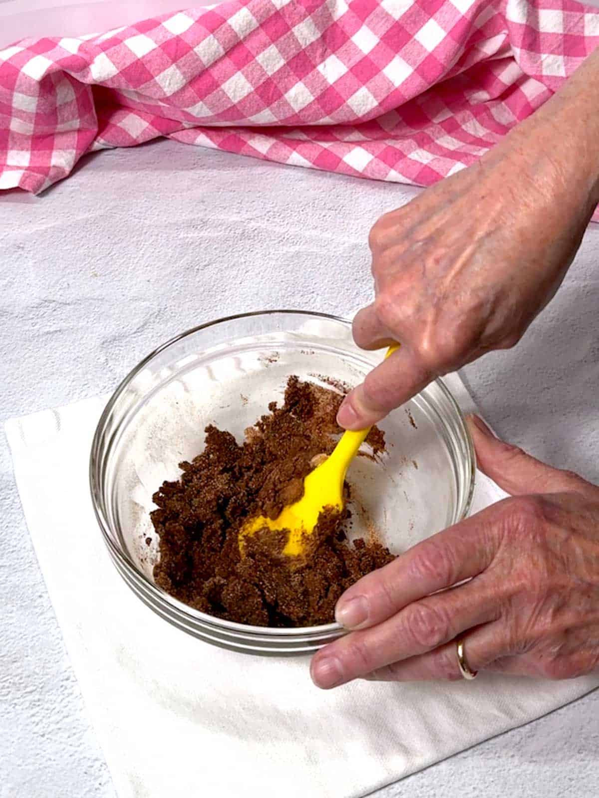 Mashing ingredients together with a silicone spatula.