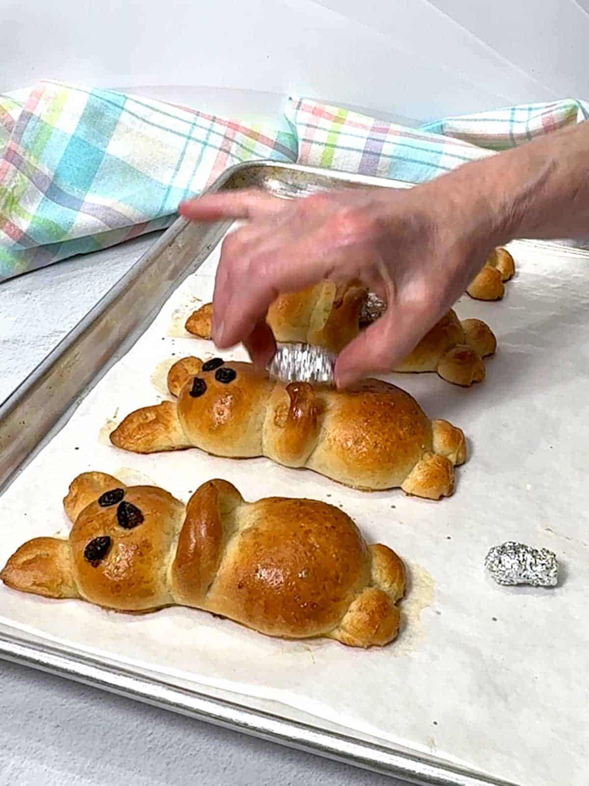 Removing the foil from the arms of the bunny.