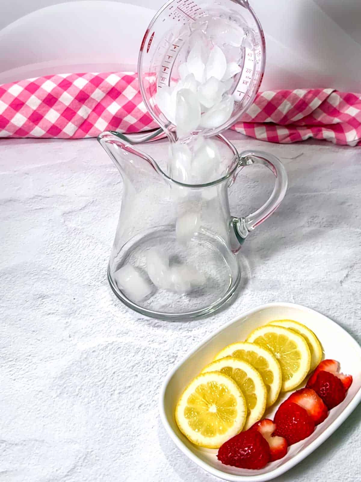 Adding ice to a pitcher.