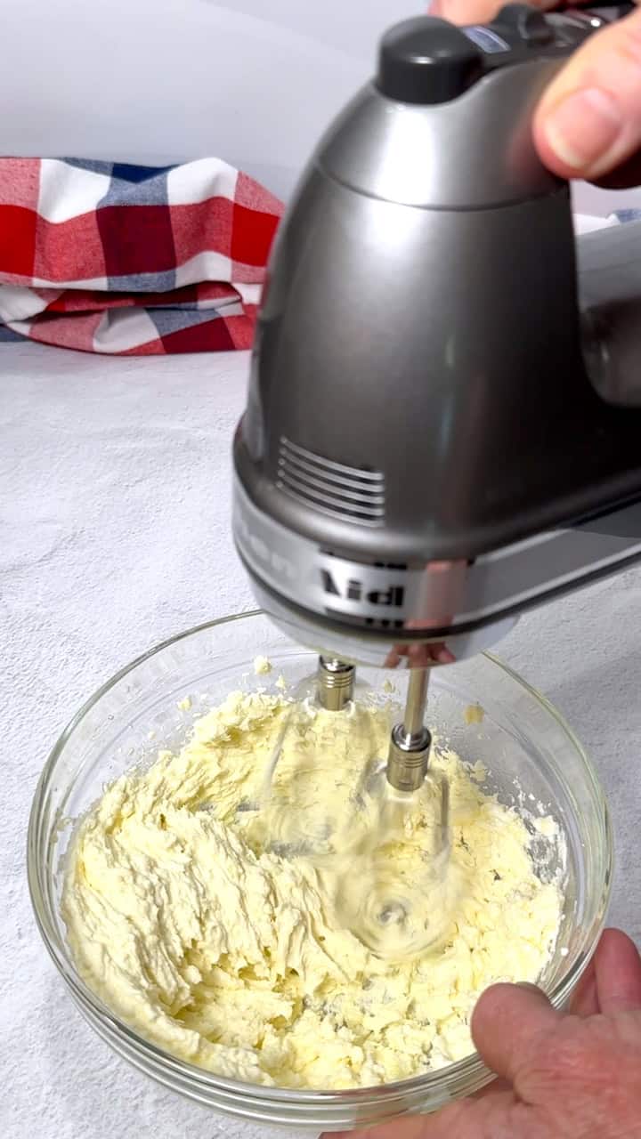 Beating the cream cheese, feta crumbles, and olive oil in a bowl.