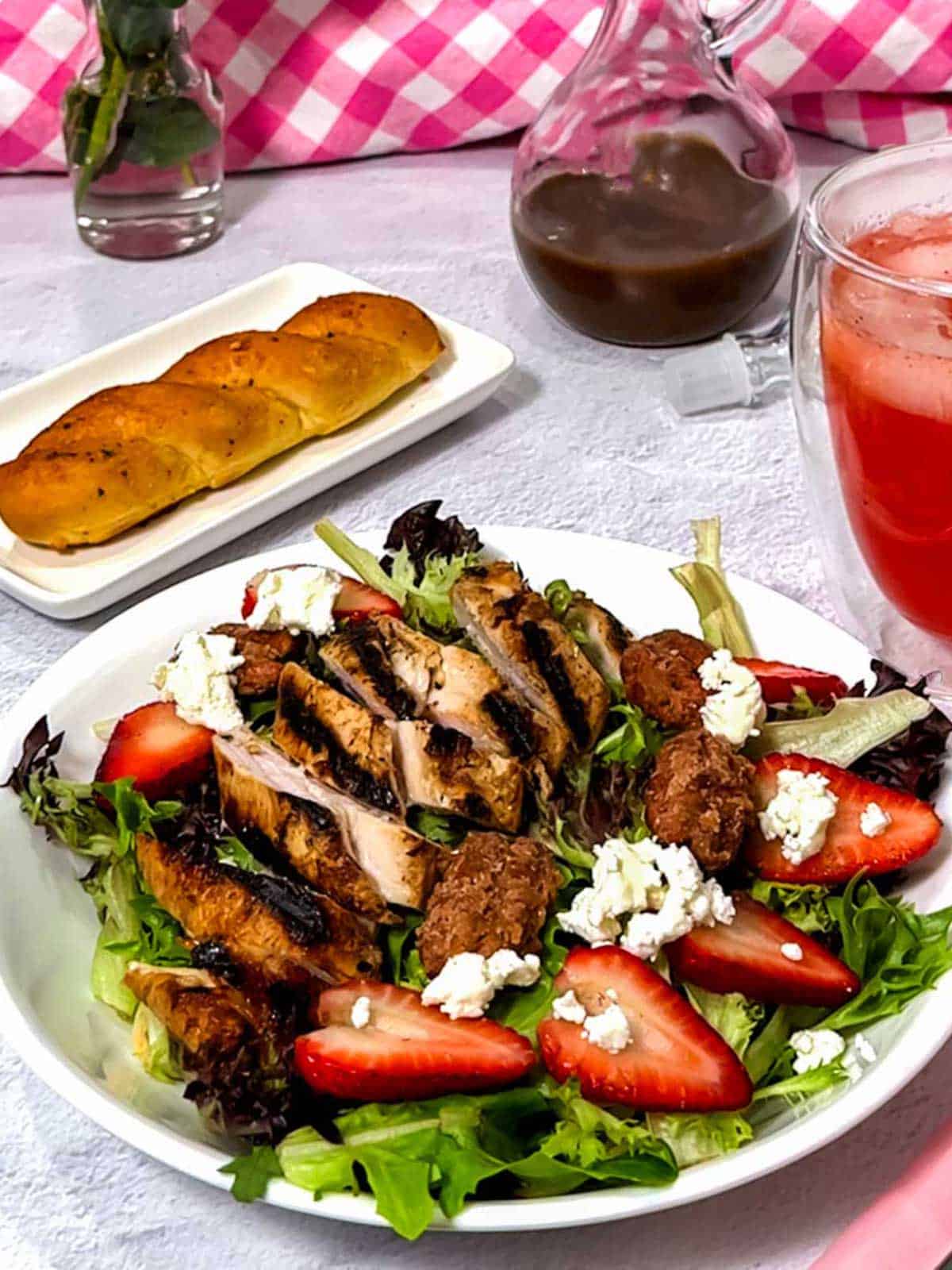 Salad with strawberries, candied pecans, and crumbled goat cheese.