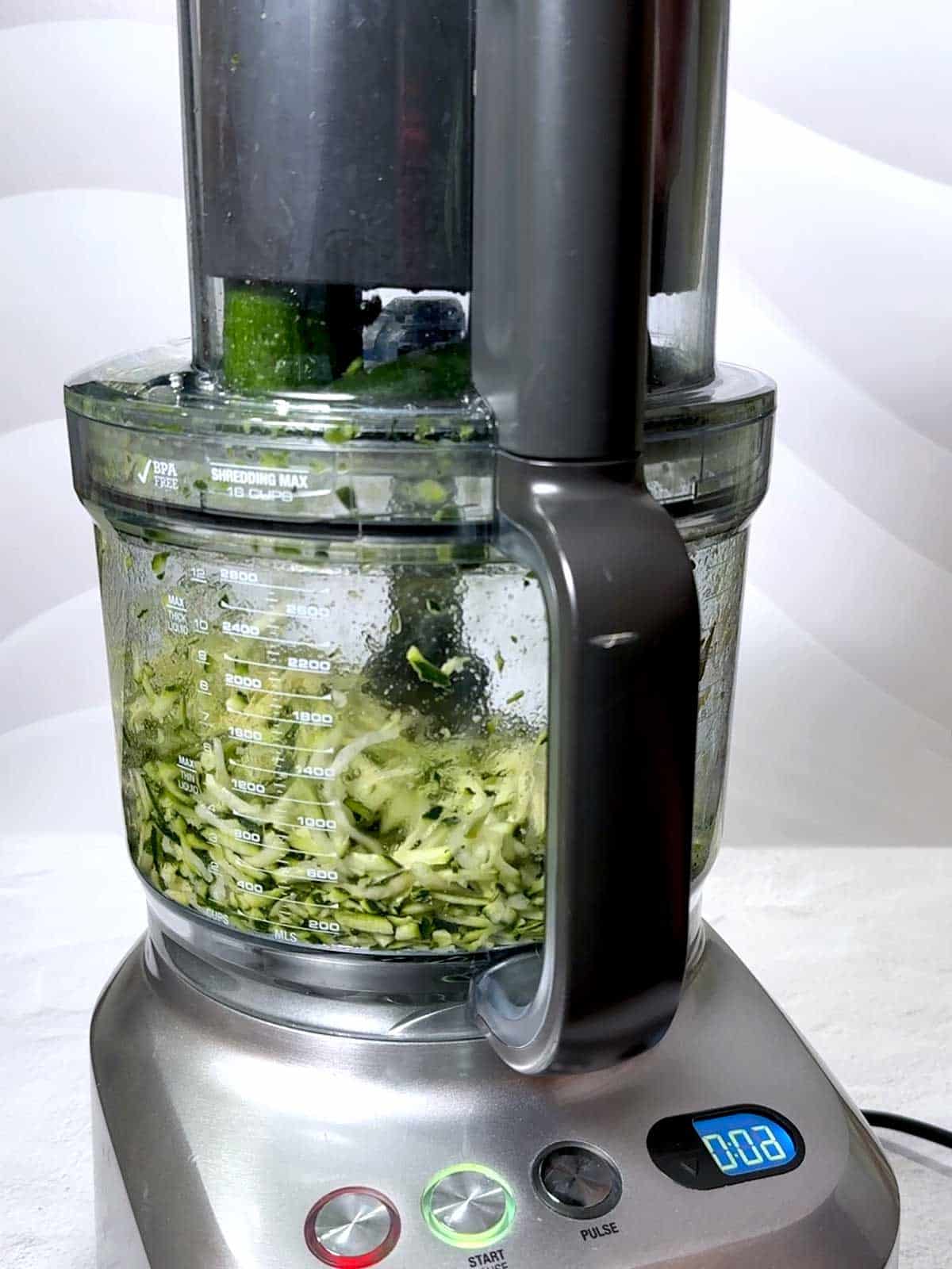 Grating the zucchini with my food processor.