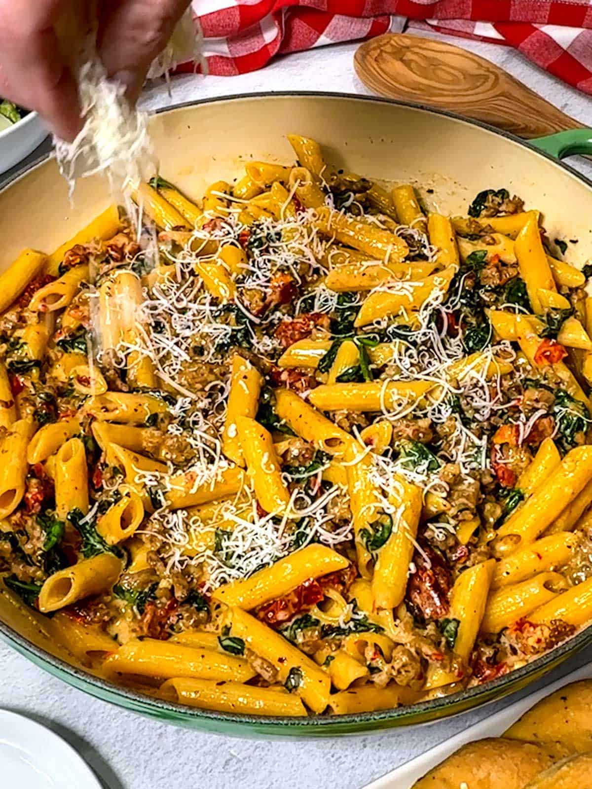 Adding Parmesan cheese to the one-pot casserole.