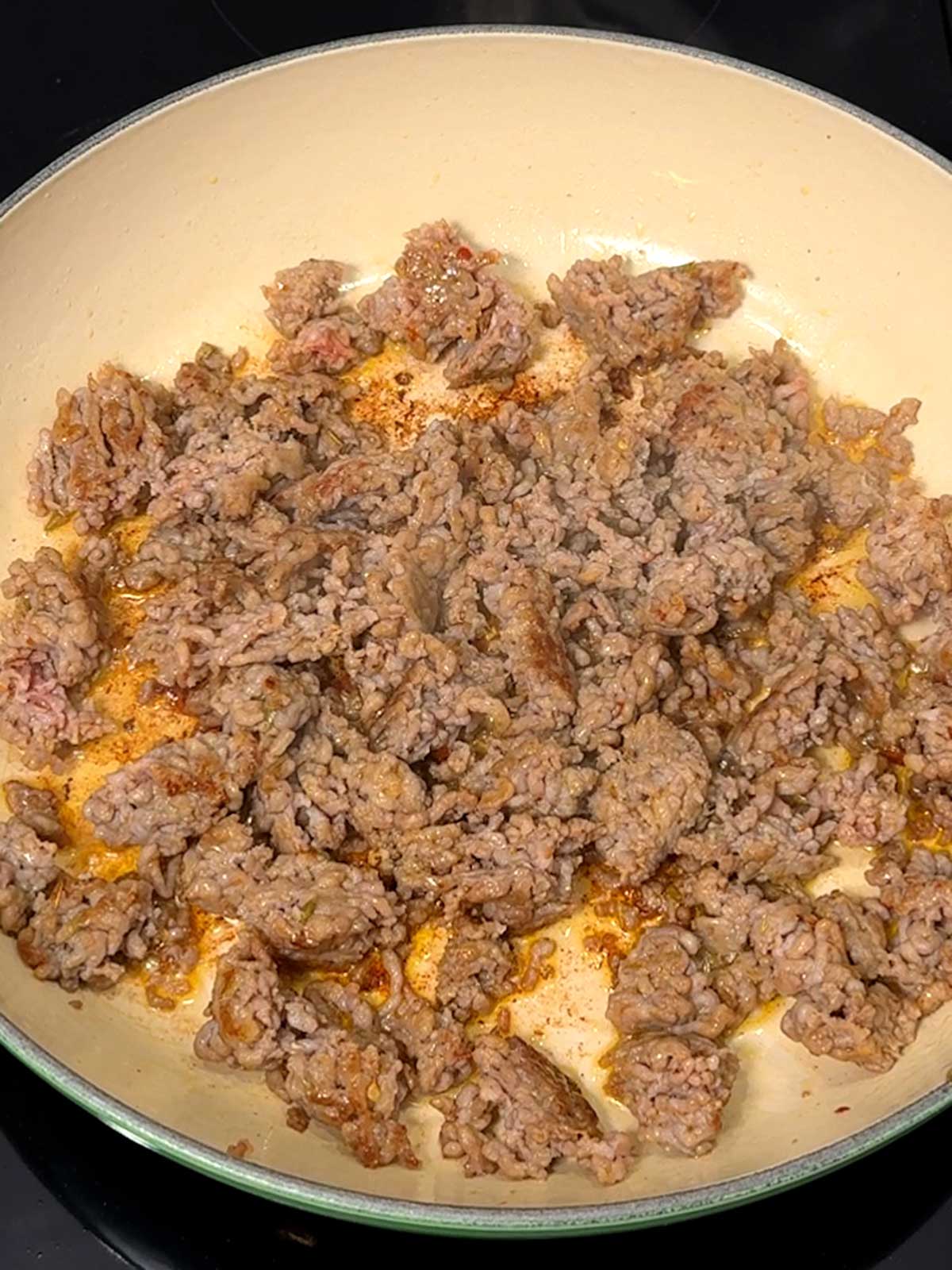 Cooked sausage in medium braiser.
