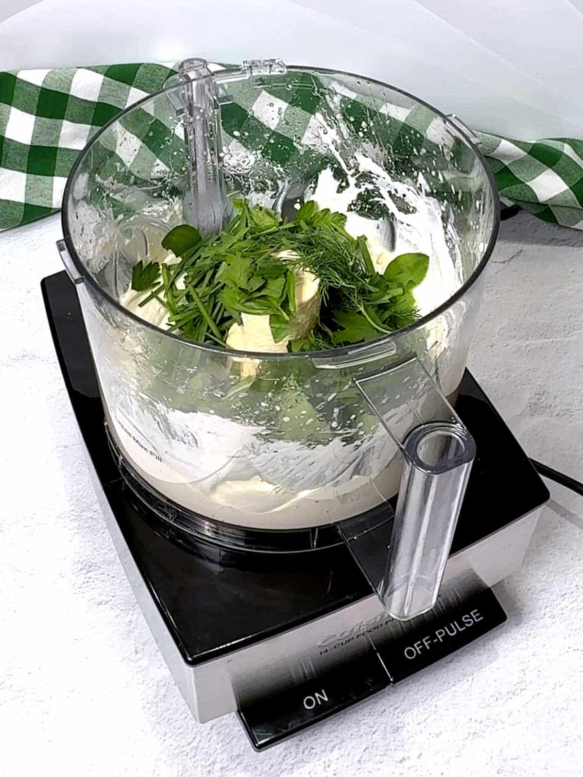 Basil, parsley, chives, and dill added to the food processor.