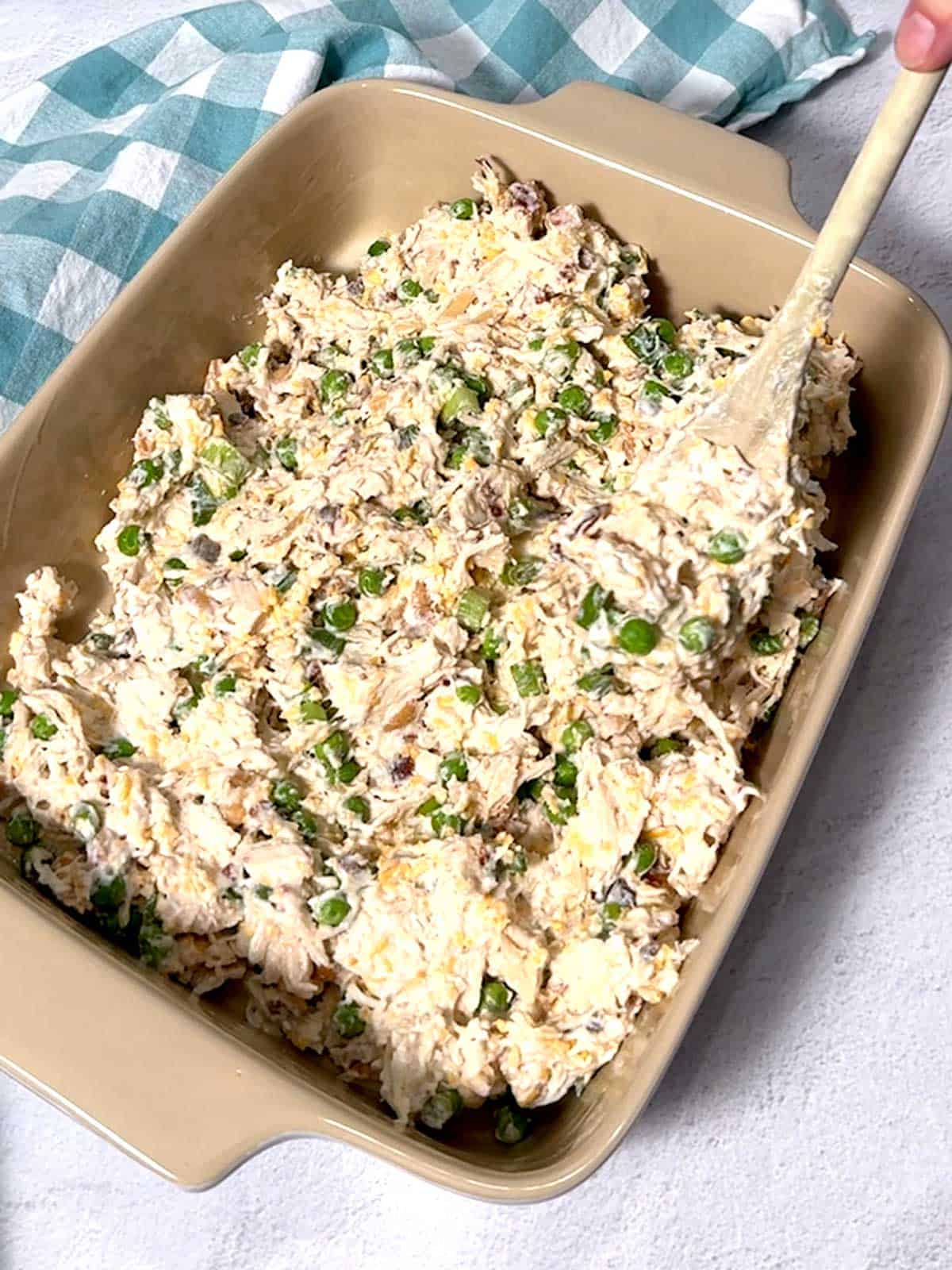 Spreading chicken mixture in the casserole dish.