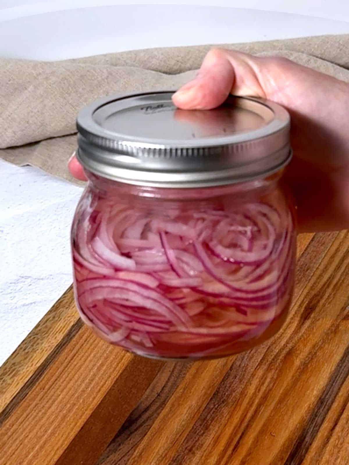 Pickled red onions in a jar.