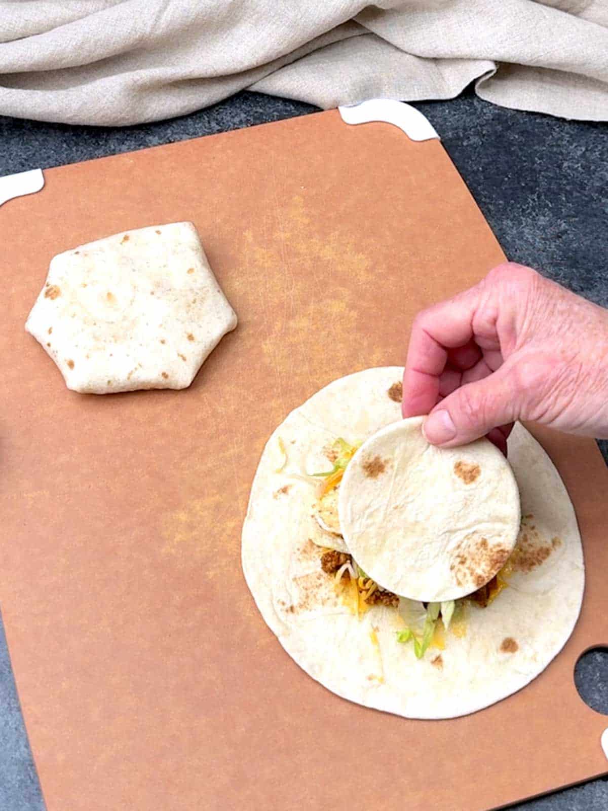 Placing the smaller tortolla on top.