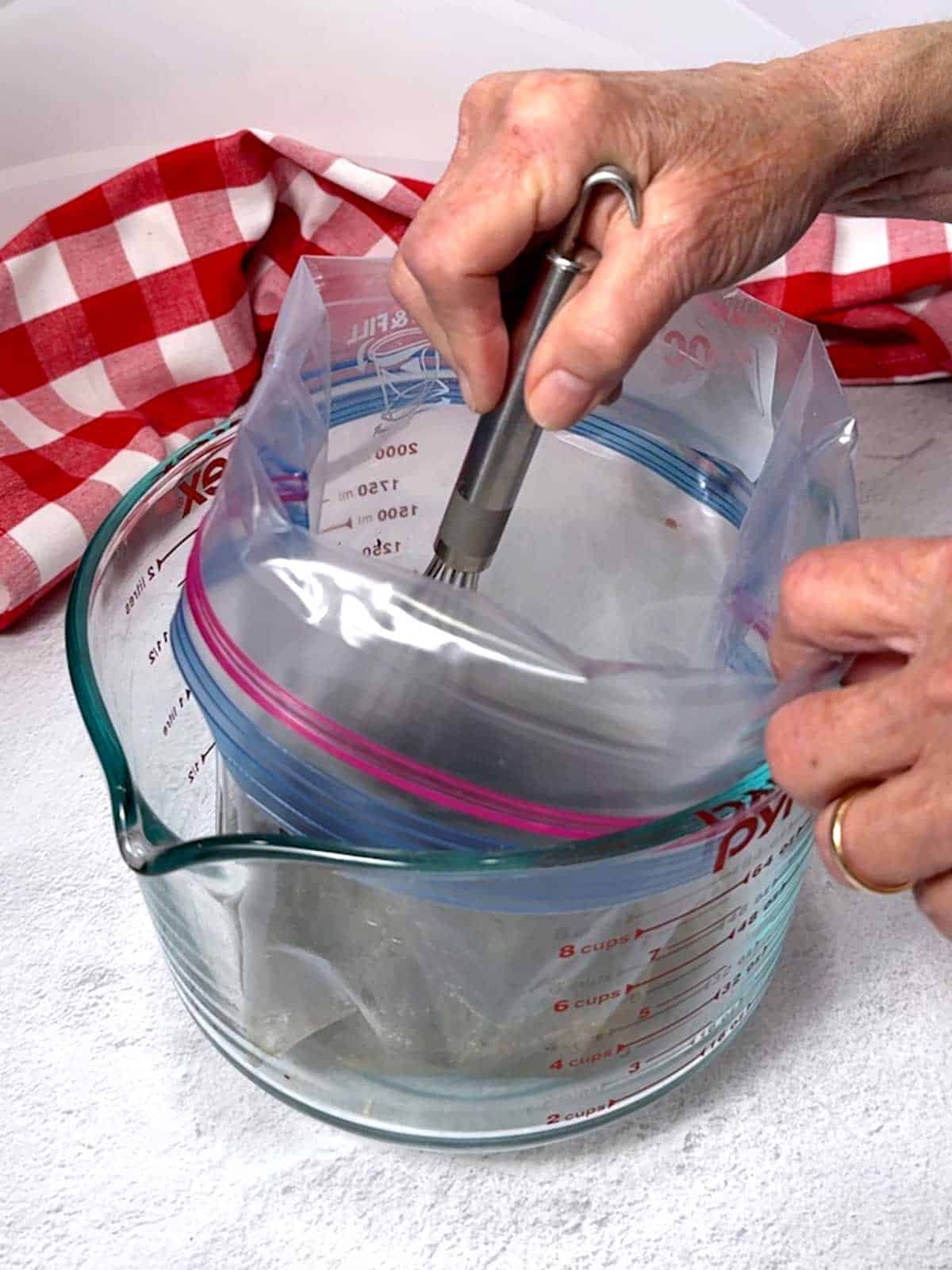 Whisking the marinade ingredients together in the Ziploc bag.