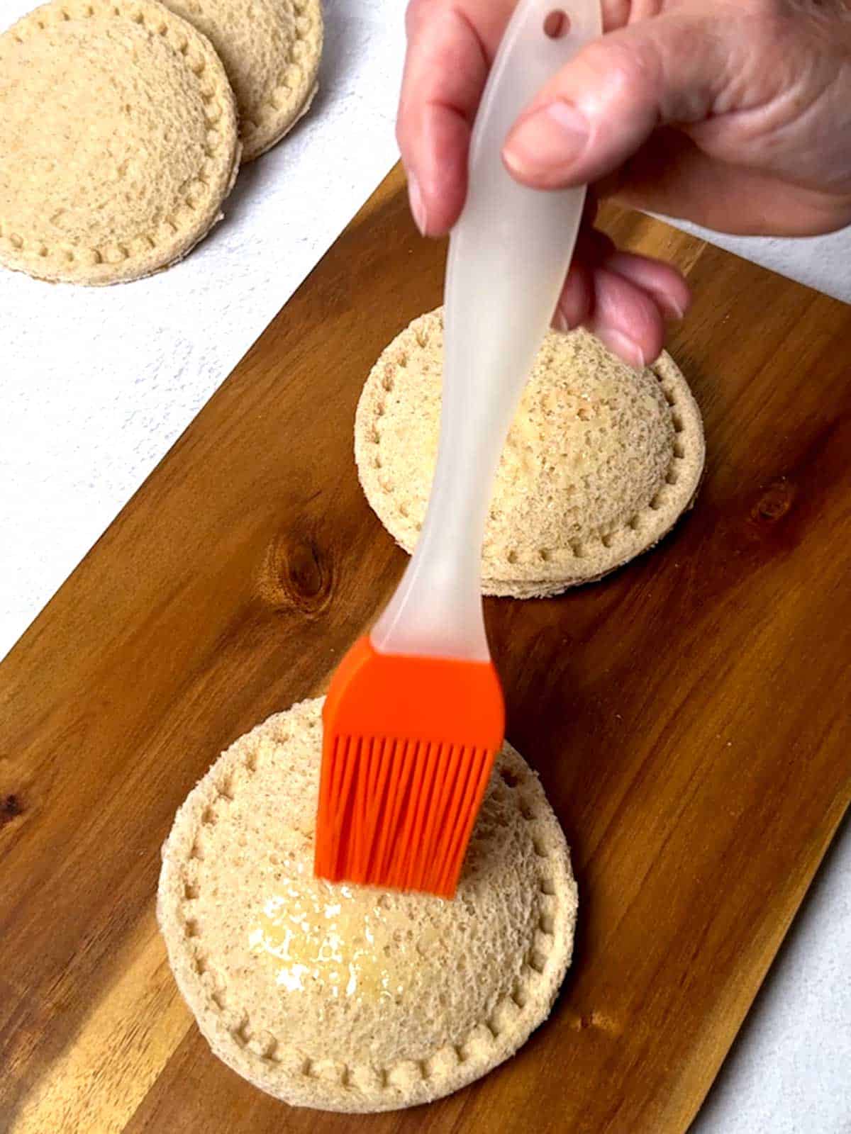 Brushing the uncrustable with butter.