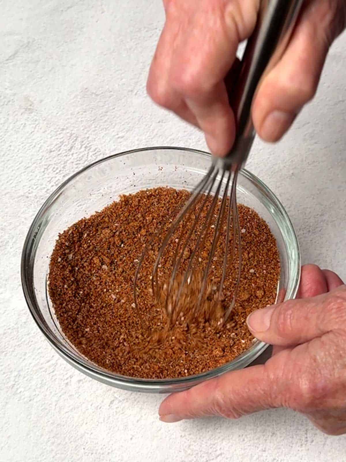 Whisking together dry rub ingredients.