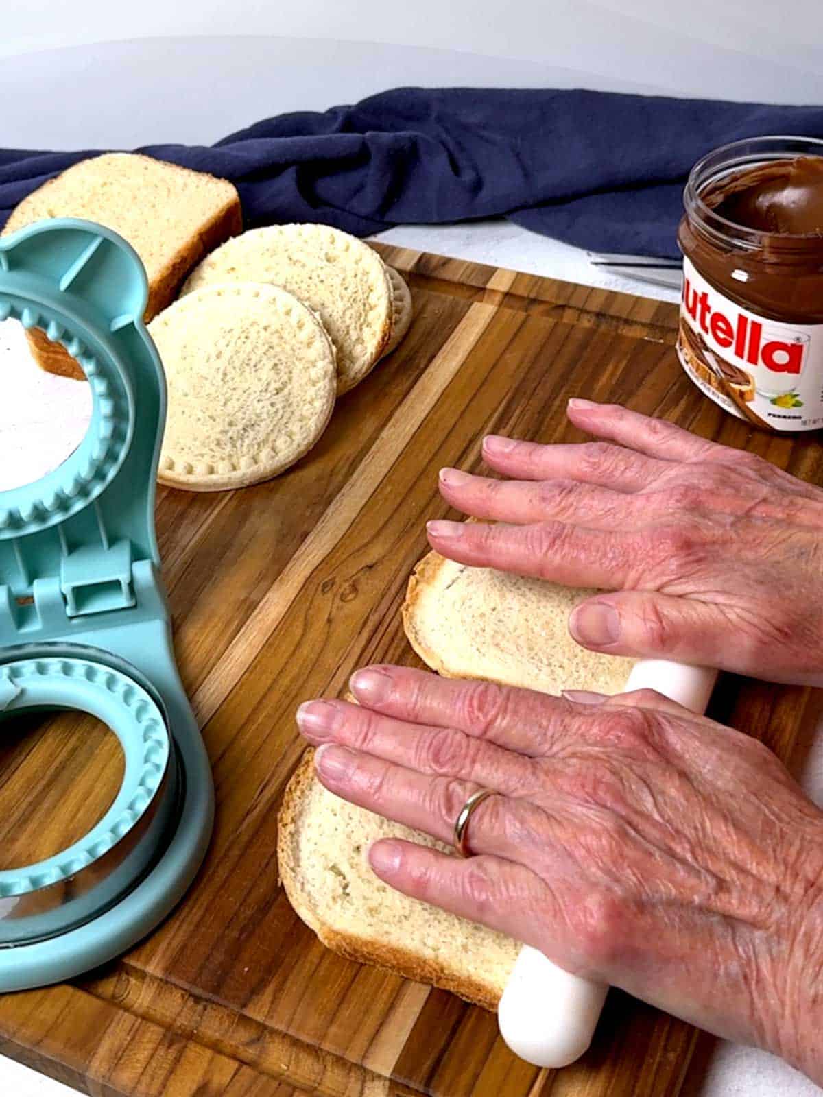 Flattening the bfread with a fondant rolling pin.