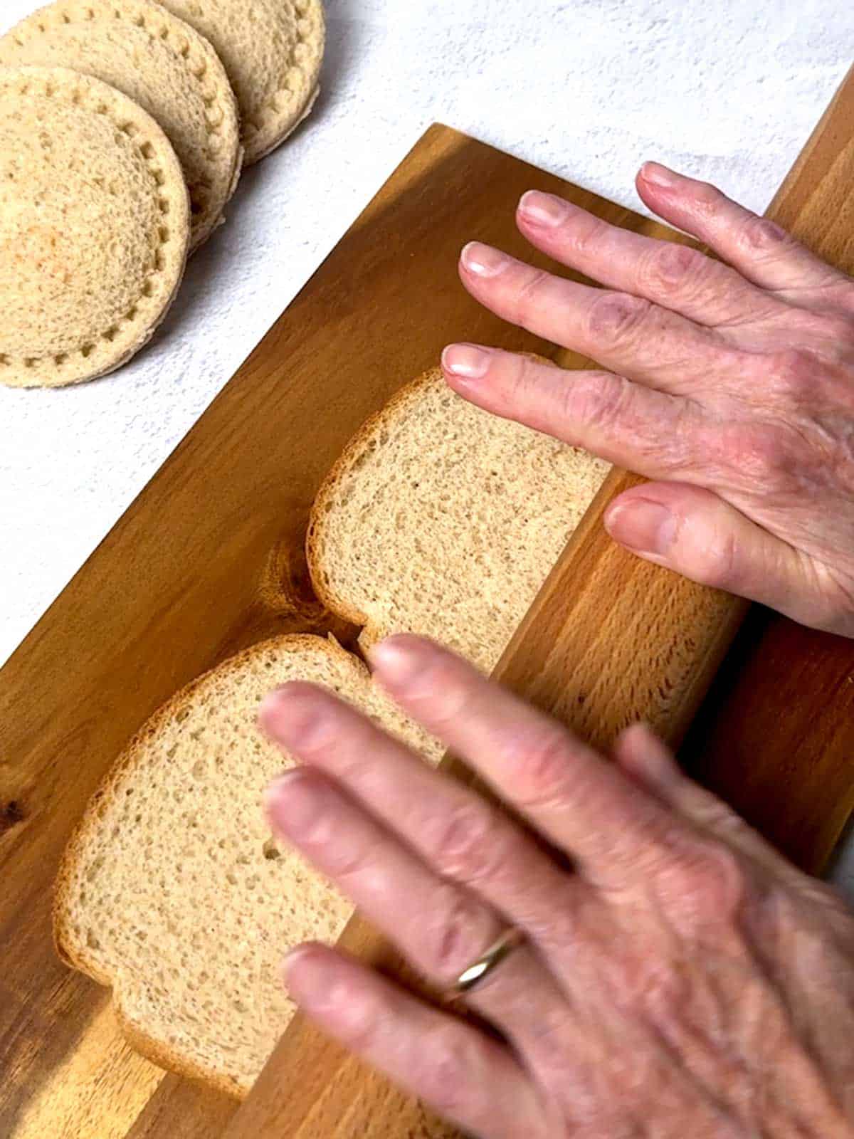 Flattening the bread with a rolling pin.