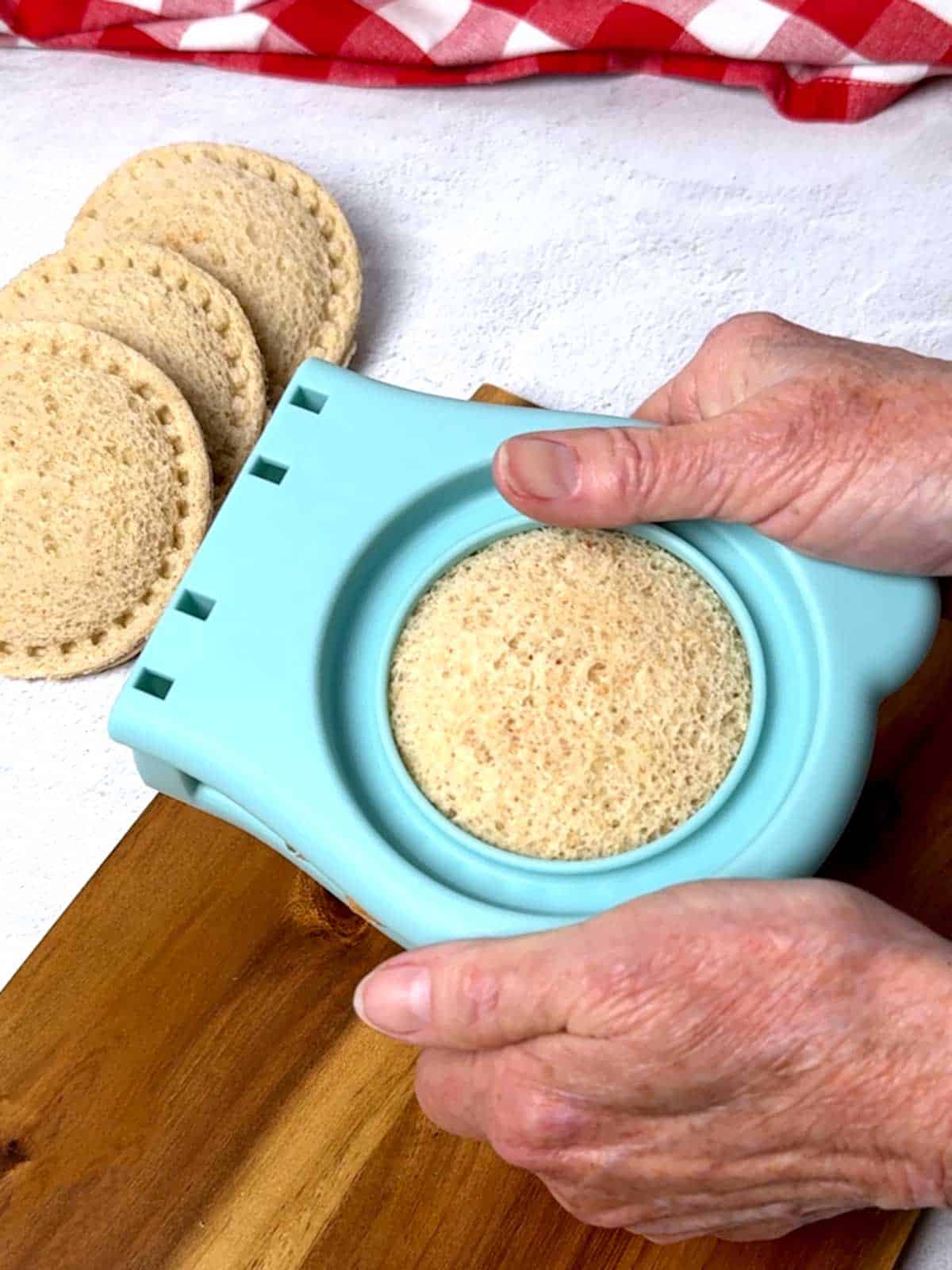 Cutting the uncrustable and sealing the edges.