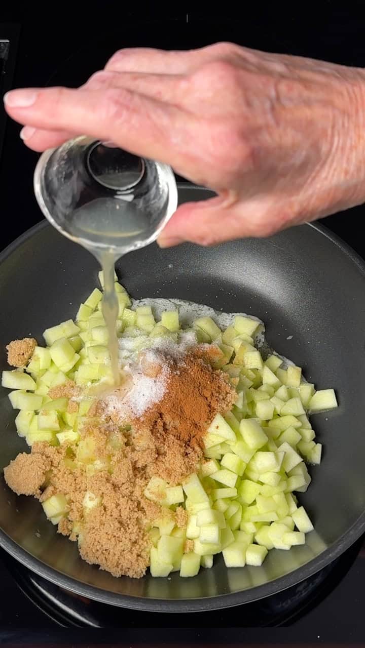 Adding lemon to the apples and other ingredients.