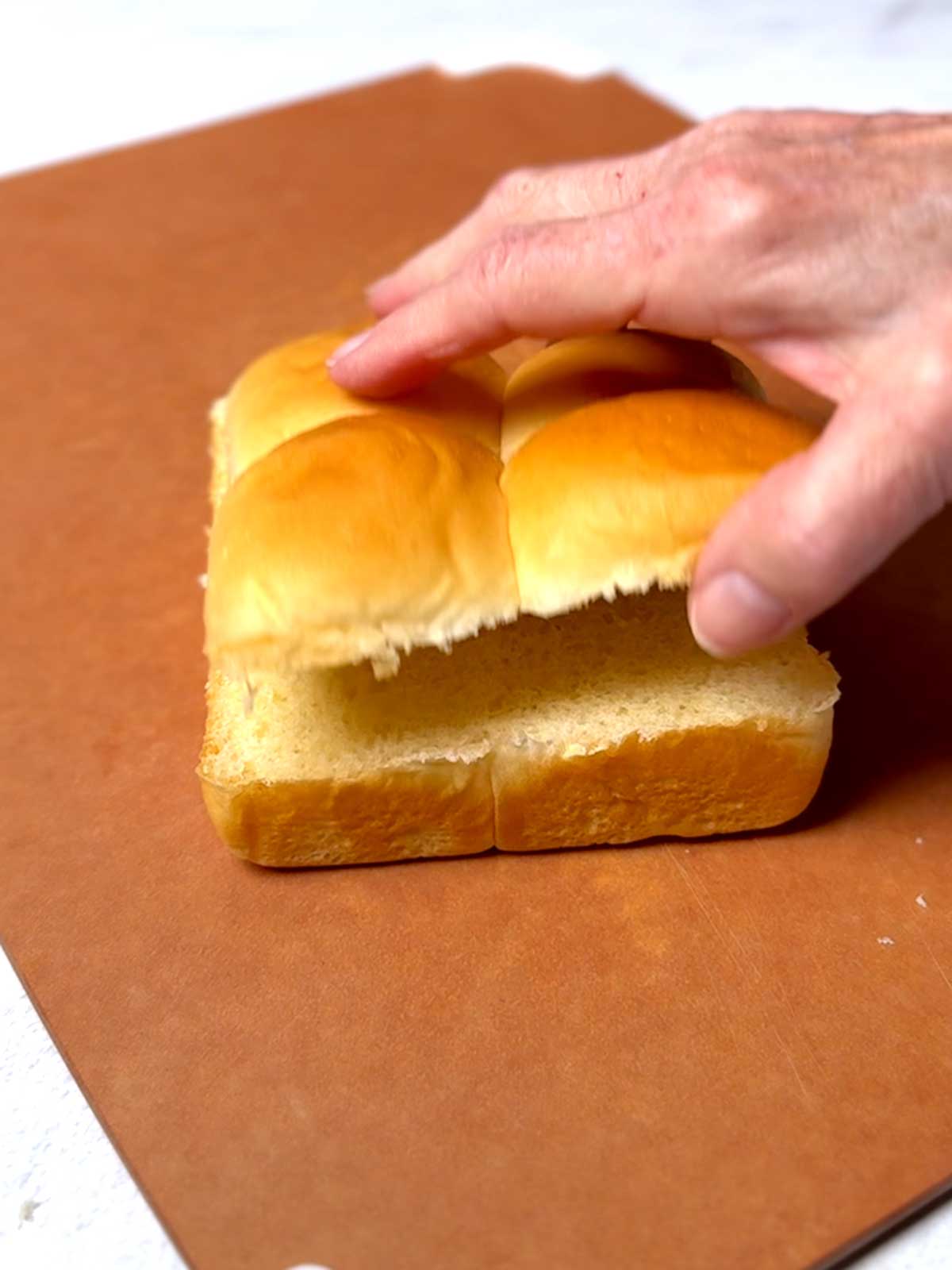 Slider buns sliced in half horizontally.
