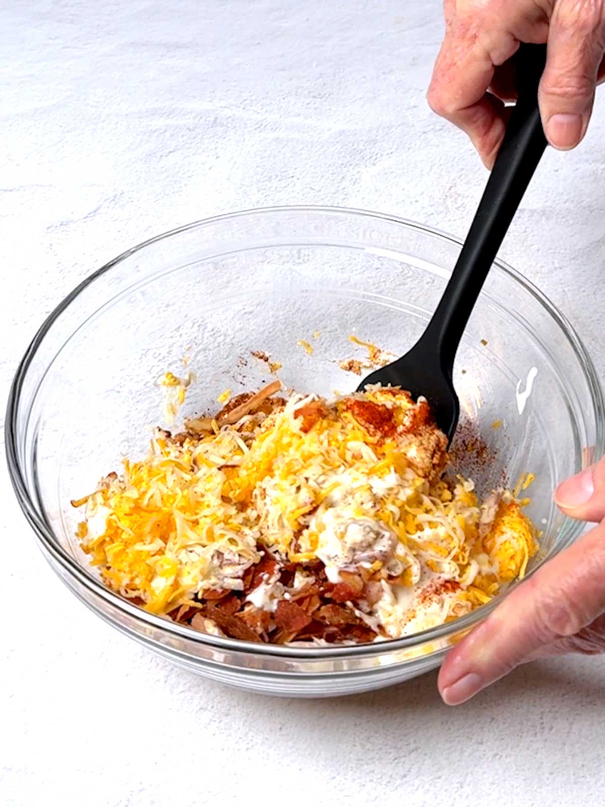 Stirring the filling ingredients together in a medium bowl.