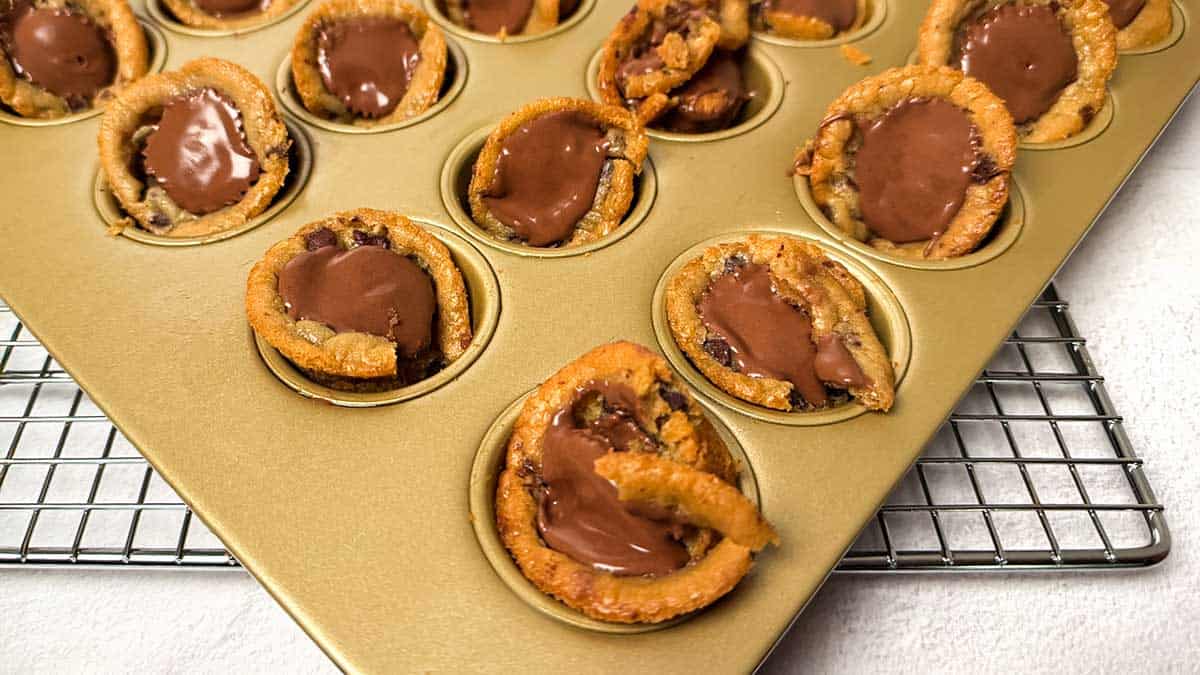 Broken pumpkin patch cookie cups after using pre-portioned dough; cups didn't set and collapsed when pressed with Reese's