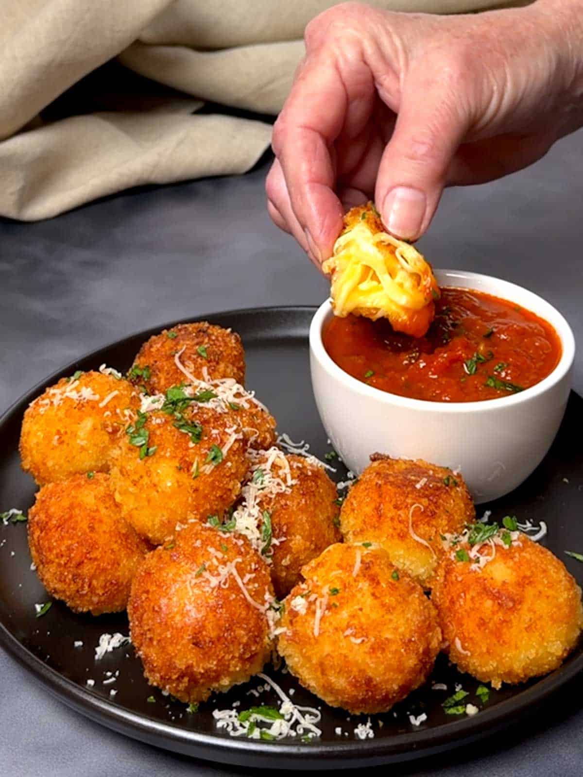 Cheese Ball dipped in marinara sauce.