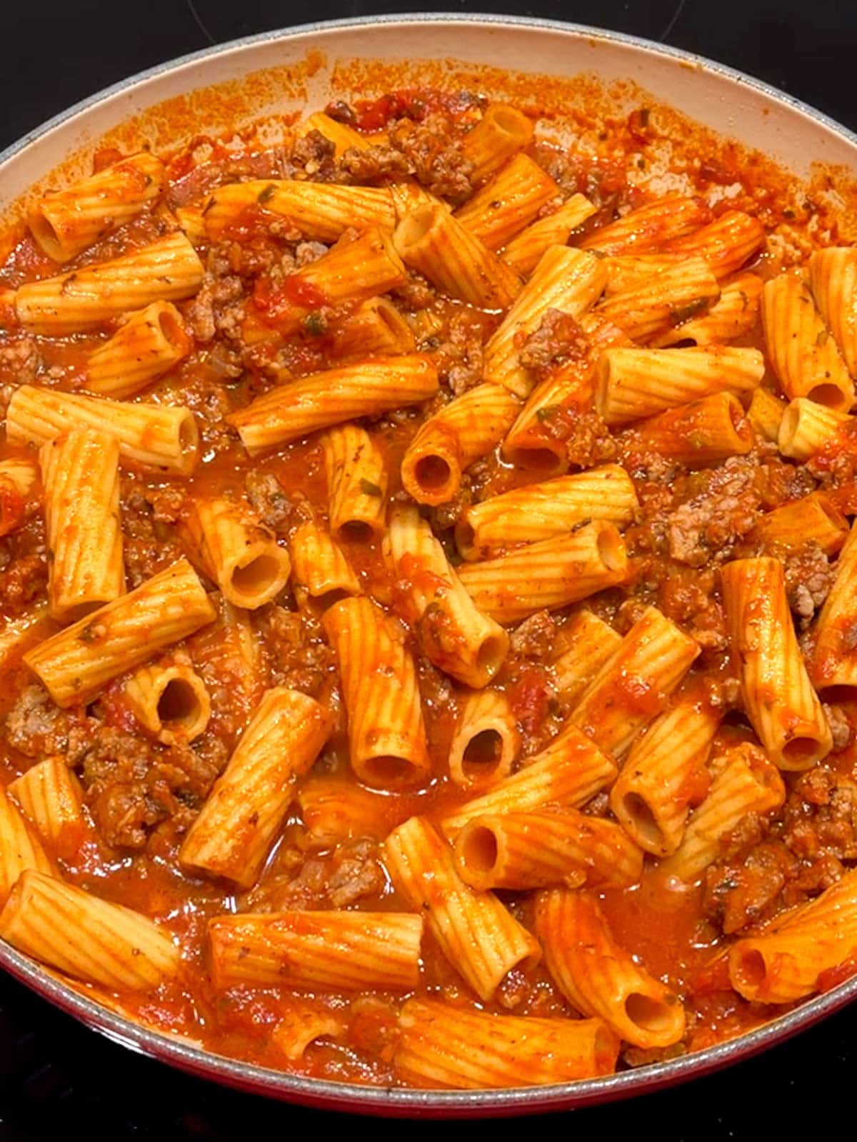 Pasta cooked with sausage in the sauce.