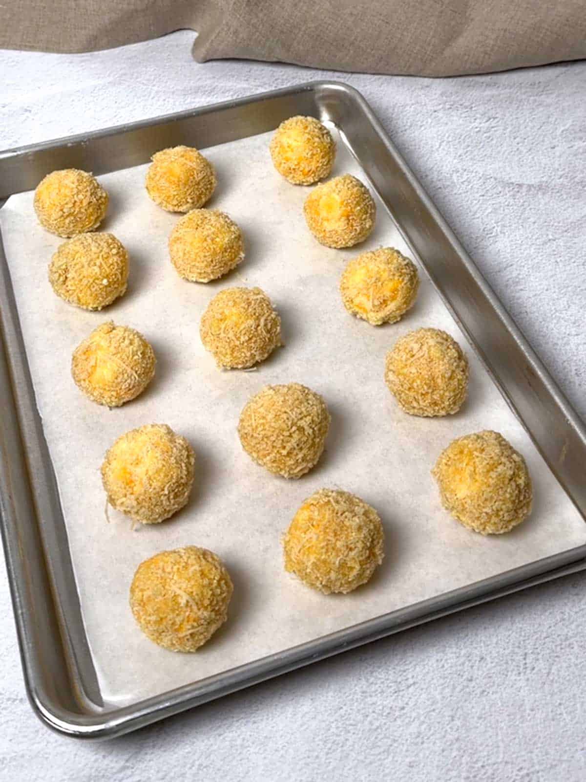 Coated cheese balls ready to chill.