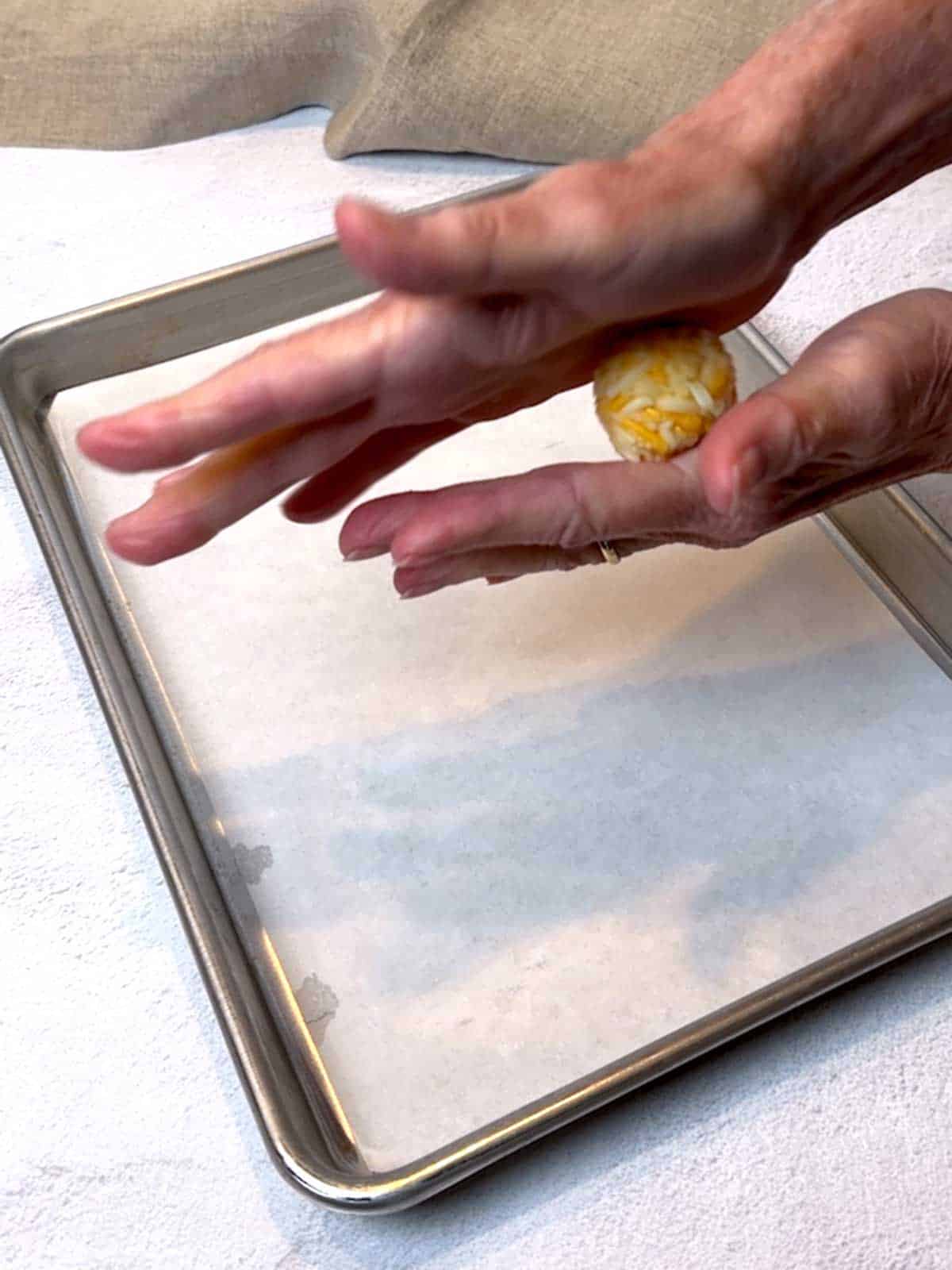 Rolling the cheese ball between my palms.
