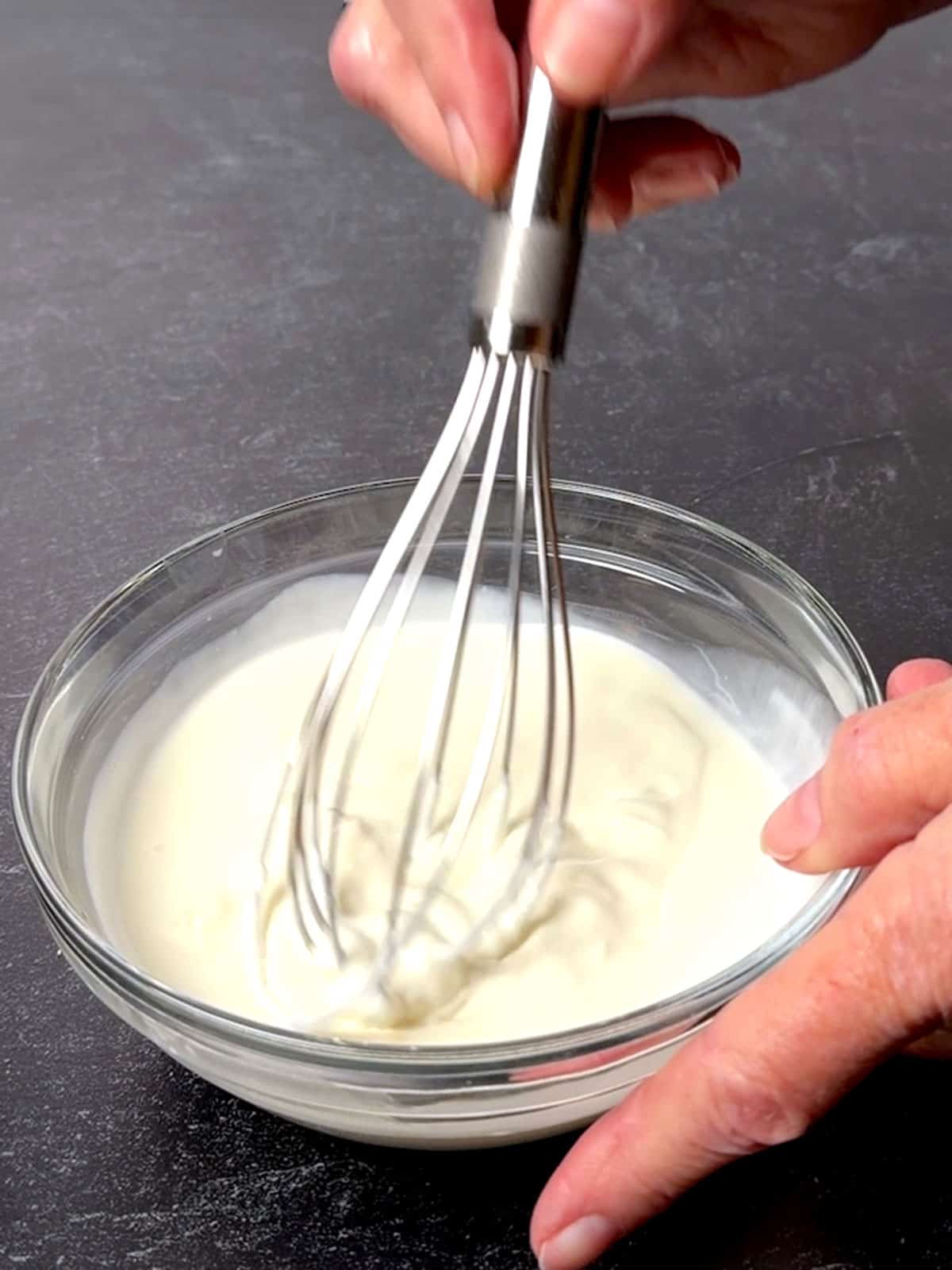 Whisking together the sour cream and heavy cream with the cornstarch fluffy.