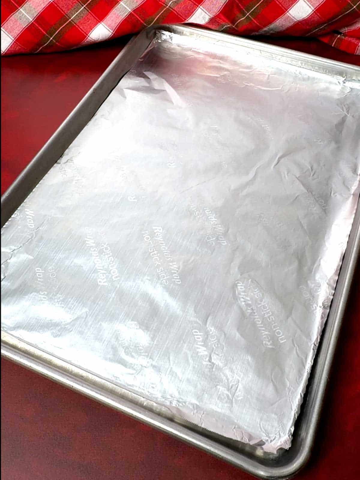 Half-sheet baking pan lined with nonstick aluminum foil.