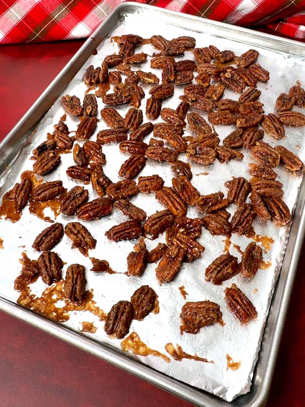 Crunchy cinnamon praline pecans cooling on the baking sheet.