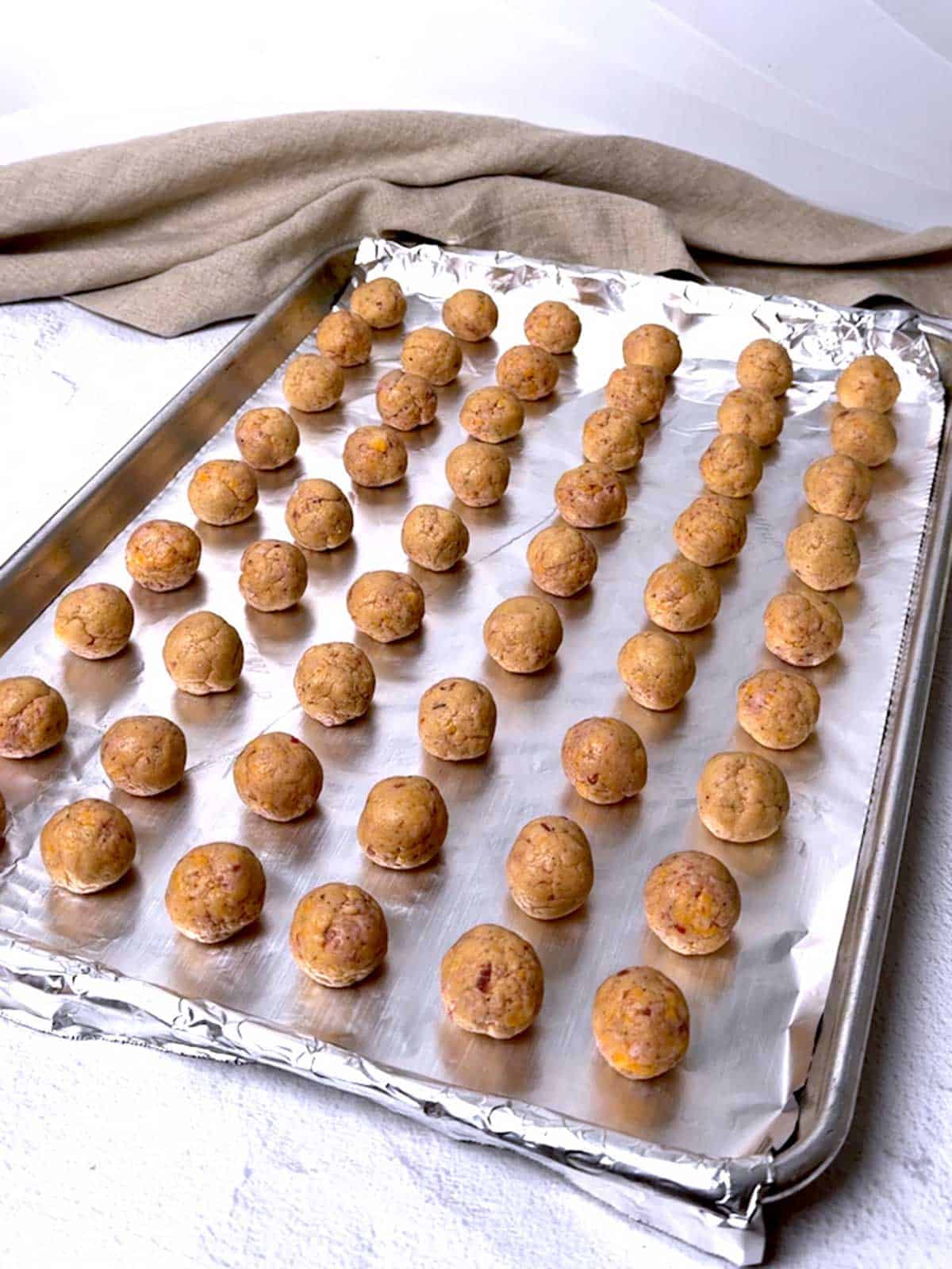 Sausage ball mixture on prepared baking sheet.