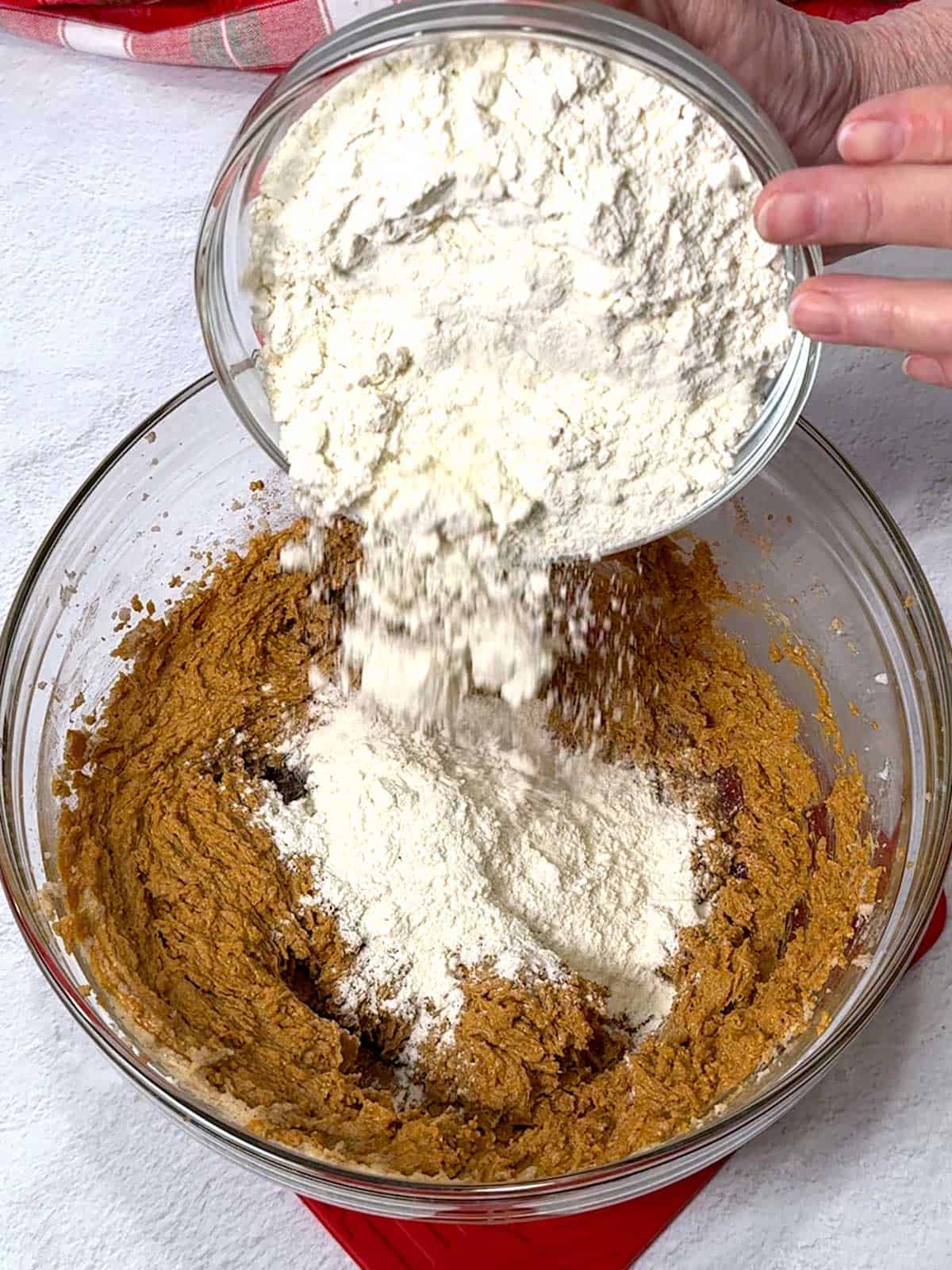 Adding the flour to the gingersnap dough.