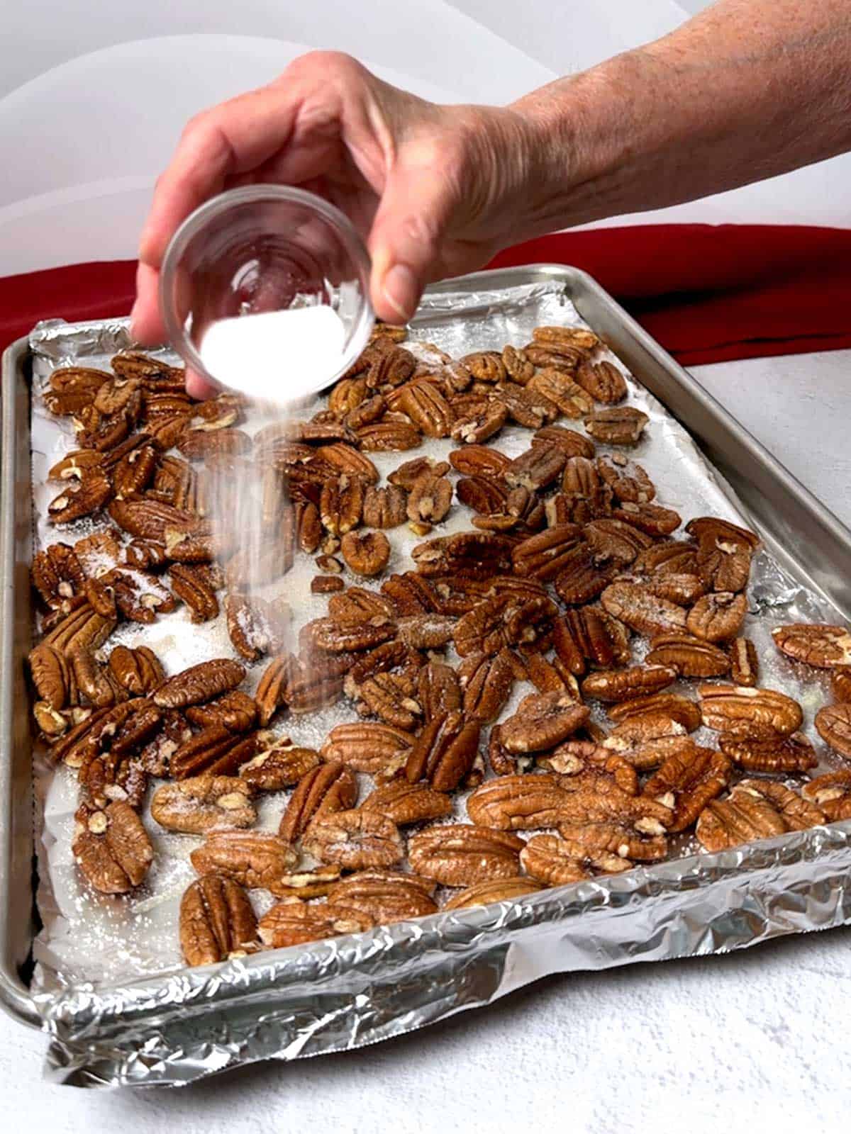 Adding sugar to the pecans.