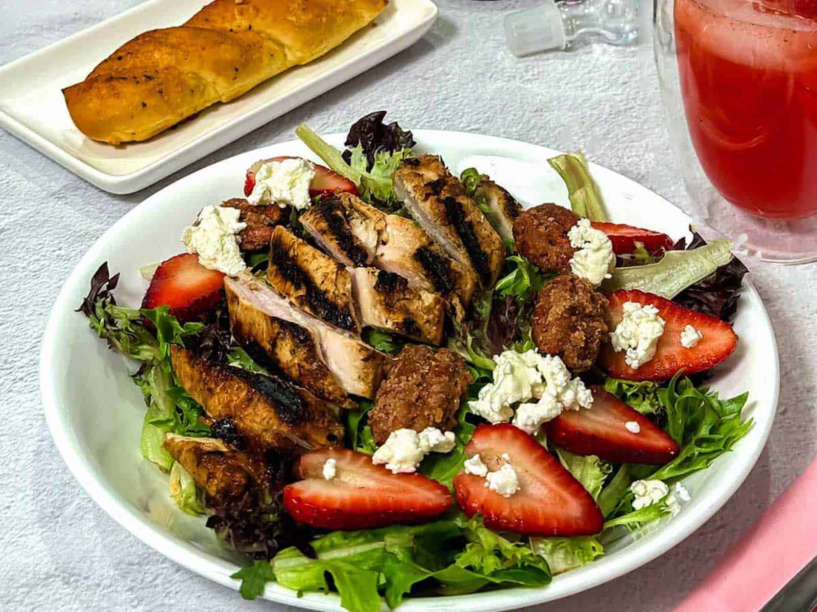 Strawberry balsamic chicken salad with greens and nuts