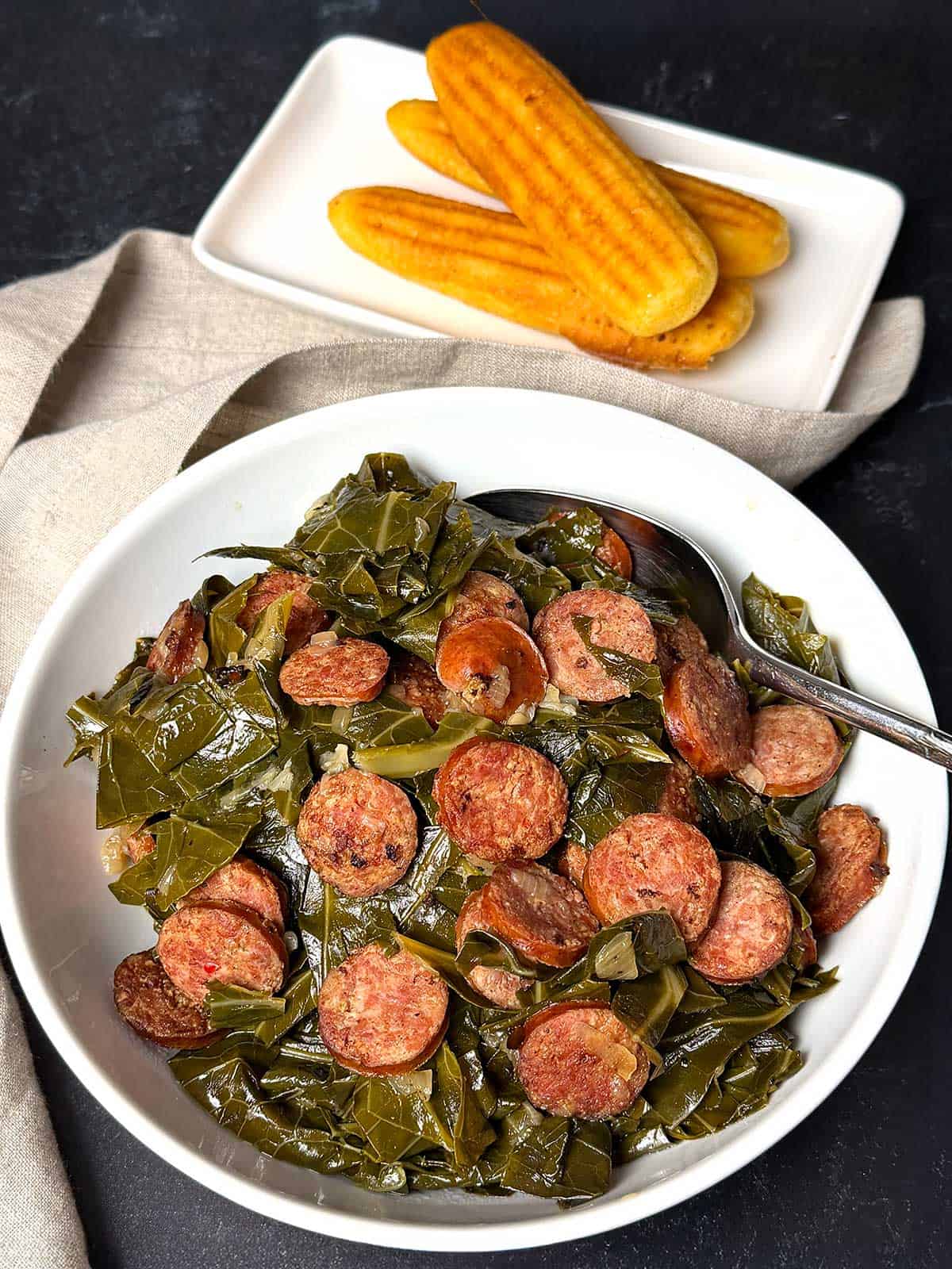 Collage greens with smoked sausage and cornbread sticks.