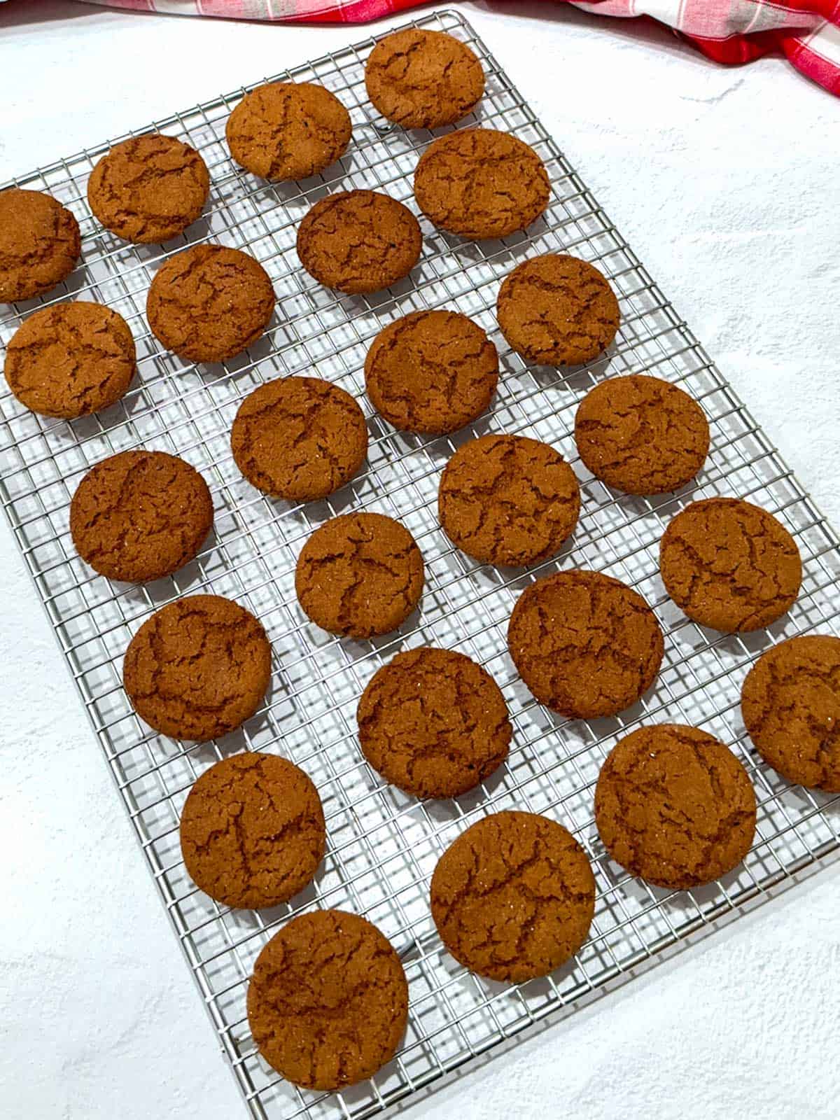 Gingersnaps out of oven and cooling on wire rack.