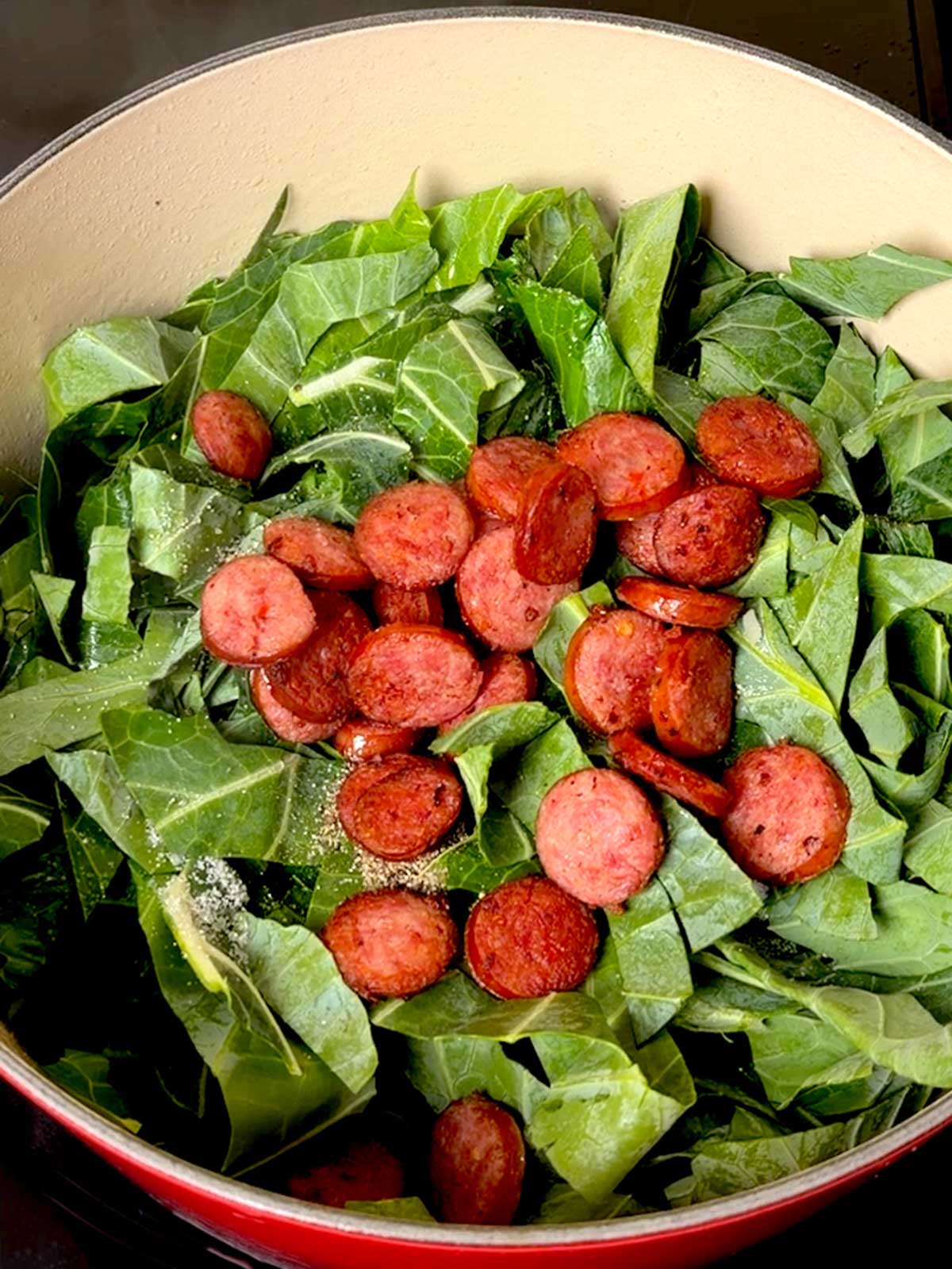 Cooked sausage added to the Dutch oven along with the sugar and pepper.