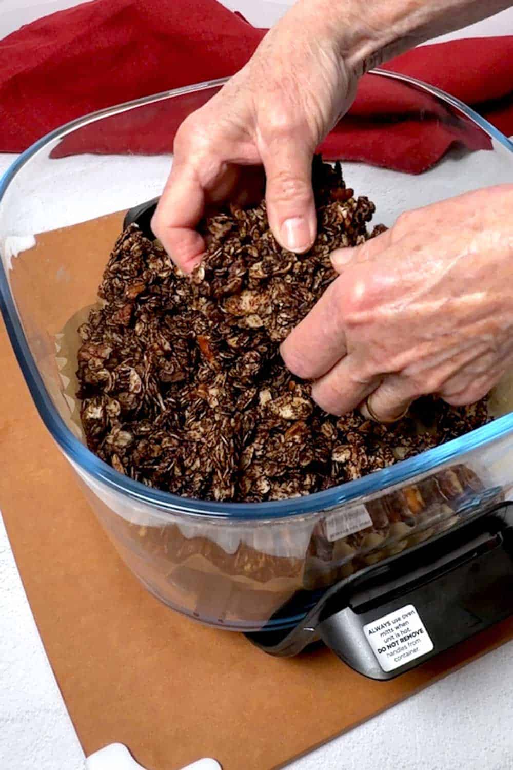 Breaking the granola into clusters.