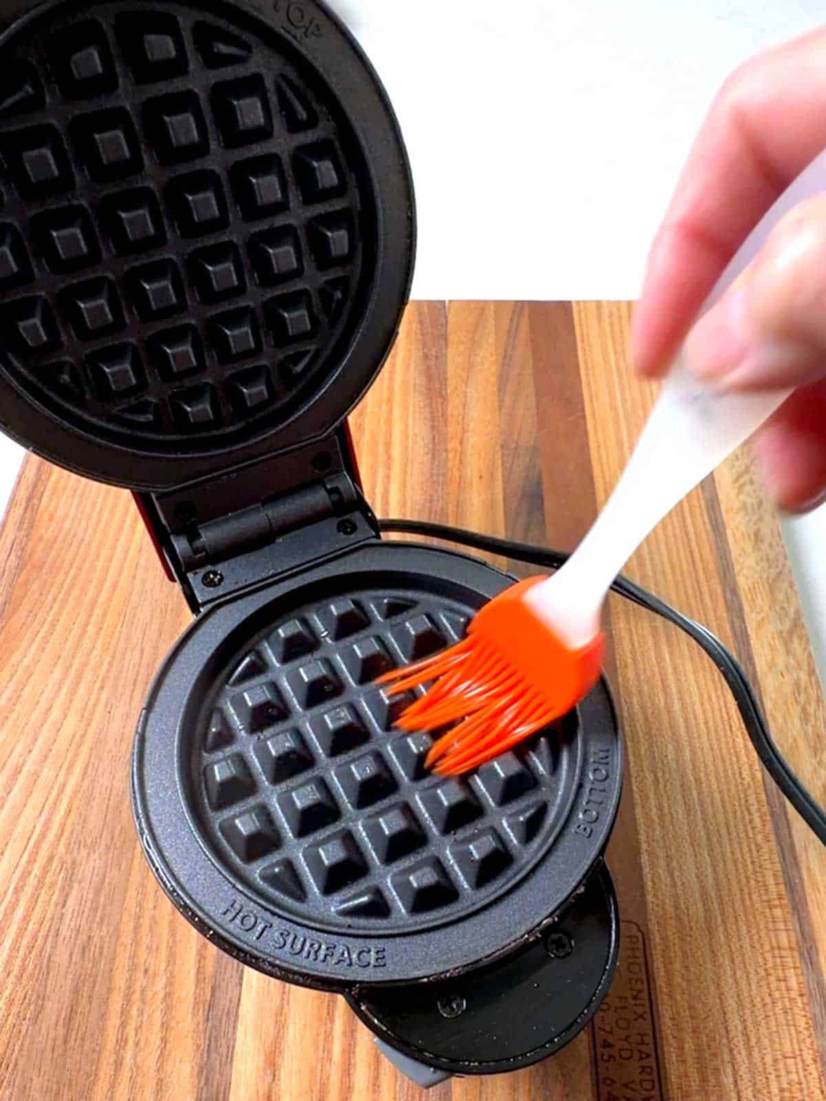 Brushing oil on Mini Waffle plate.