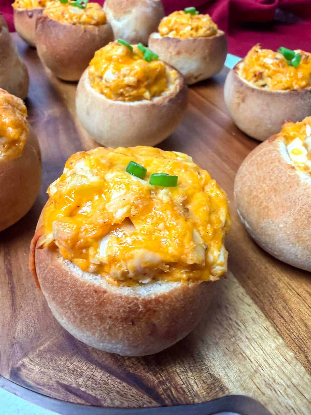Buffalo chicken mini bread bowls with melty cheese.